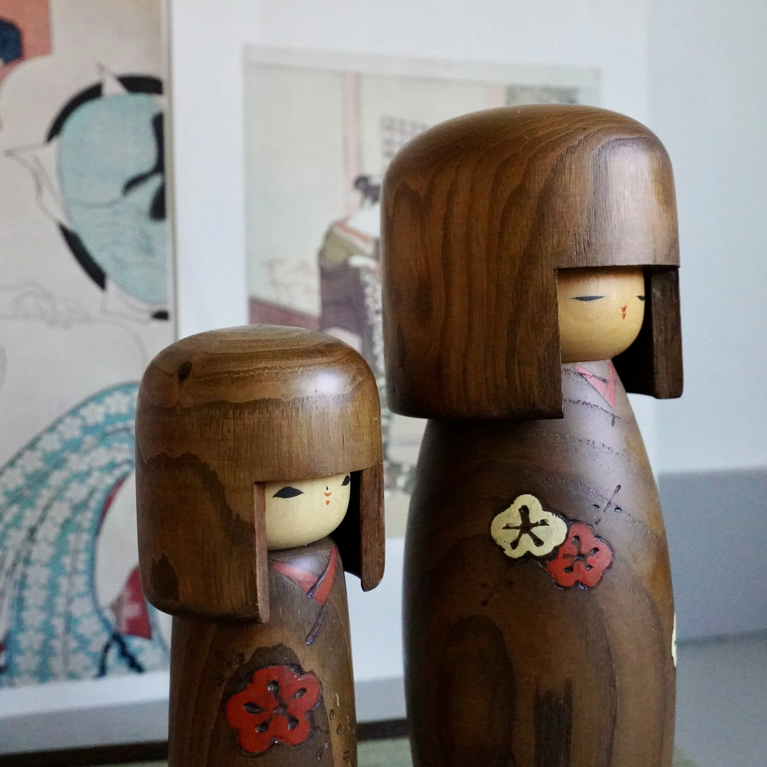 Usaburo kokeshi pair natural wood hair ume plum blossom styled face angle view