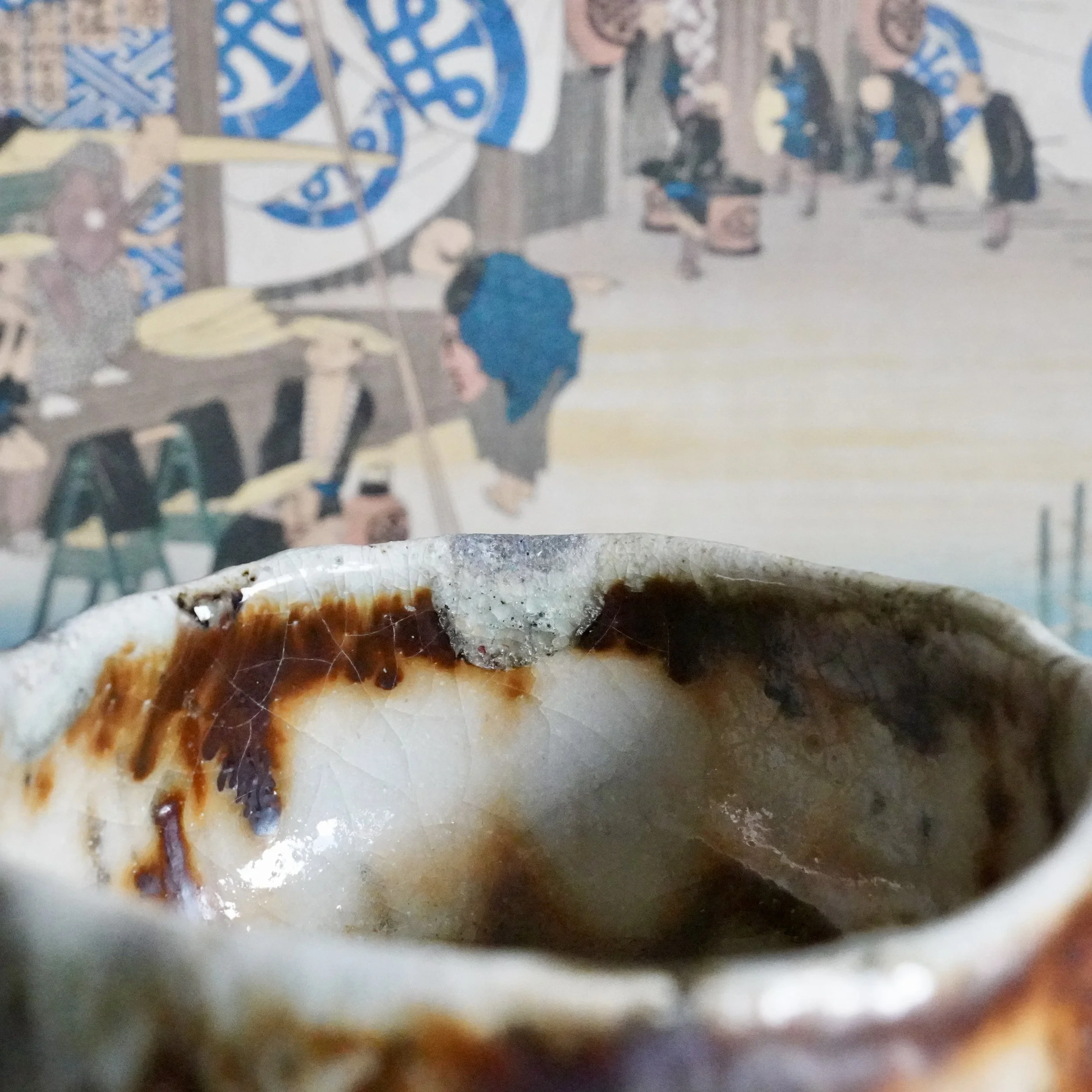 Deguchi Eiji wood-fired chawan, close-up of the interior showing crackled white glaze with mottled brown, rust, and a distinct grey-blue patch on the rim.
