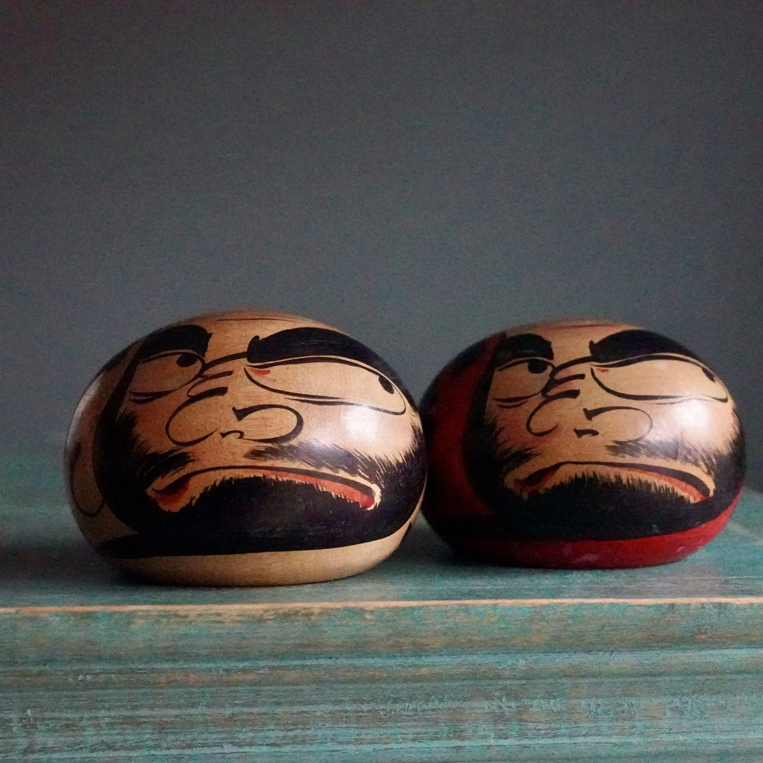 Tsugaru daruma face close up, thick black brows and beard, signed Satō Zenji, Nuruyu Onsen Aomori