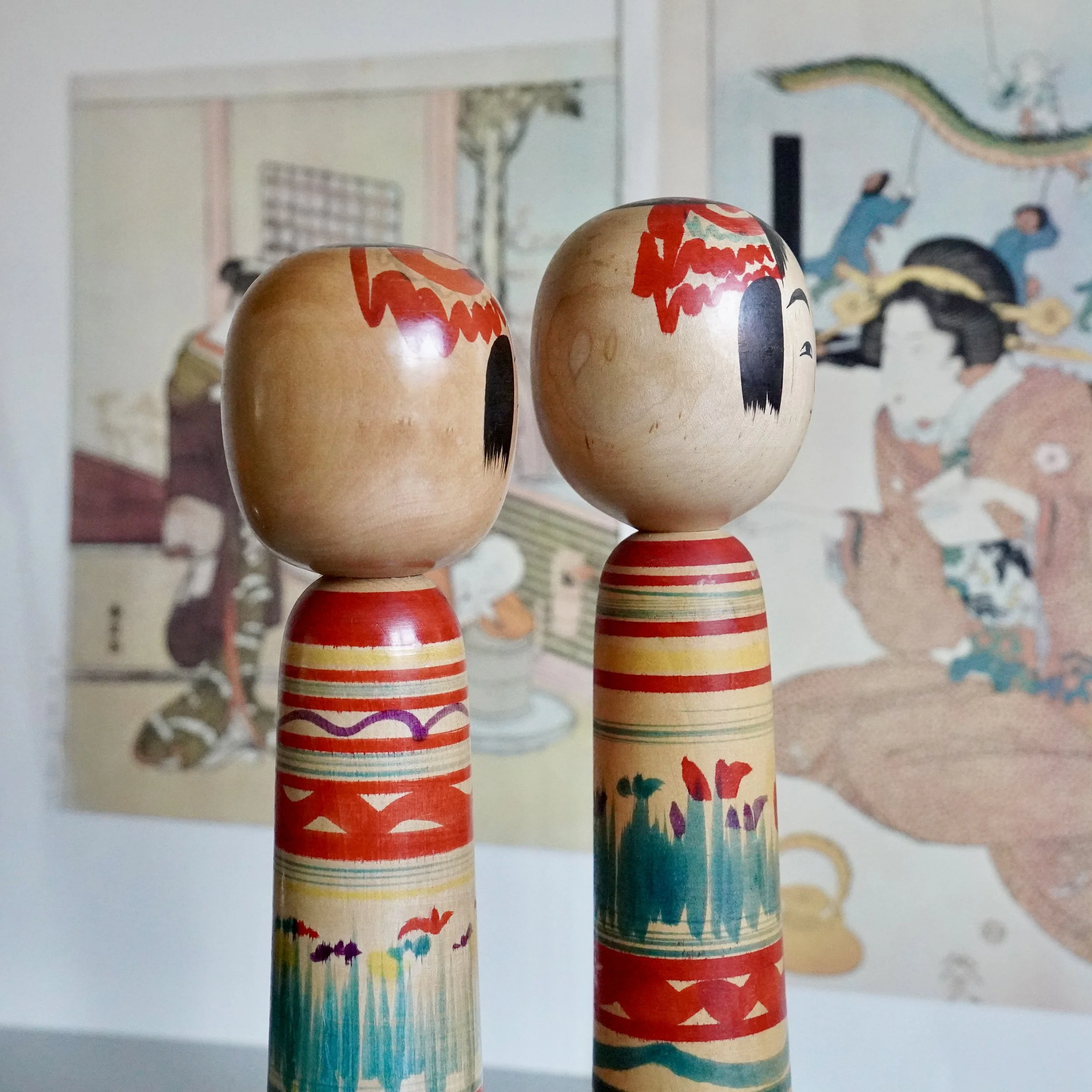 Close-up of kokeshi doll heads showing natural wood grain and turning head joint.