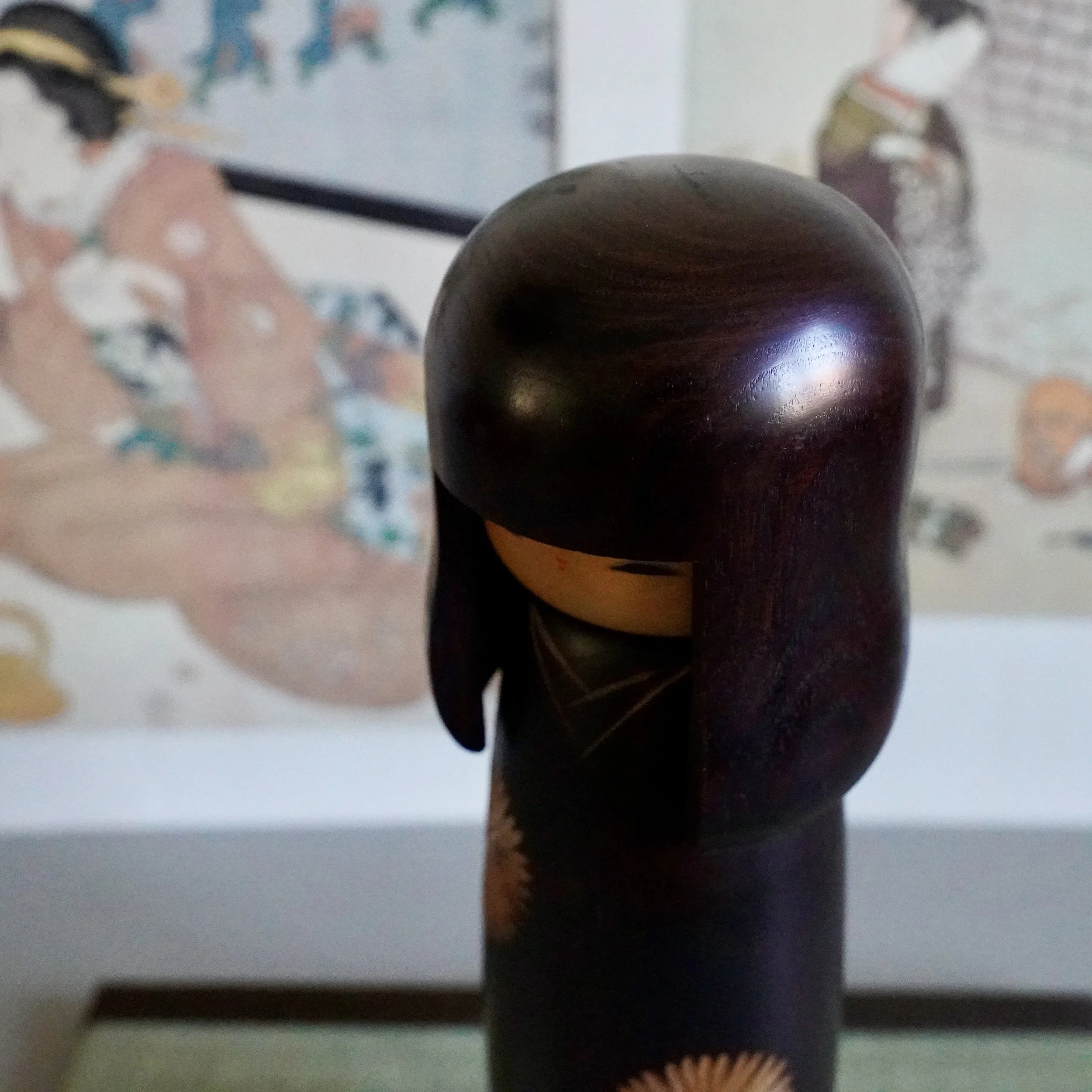 Kokeshi head detail from behind, dark stained wood, smooth rounded dome, Showa period Japan