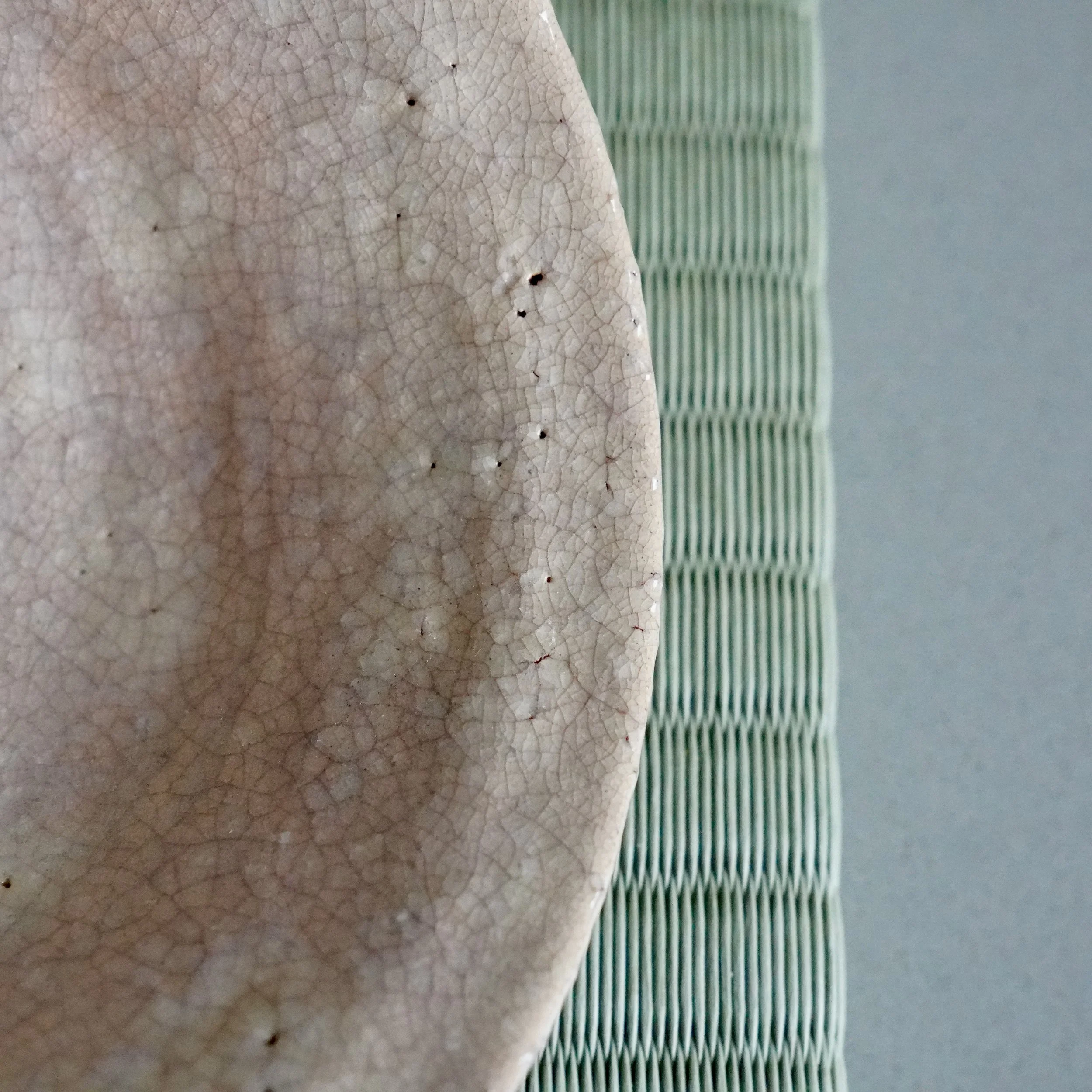 Macro detail of Hagi-yaki glaze crackle along the rim, fine kan'nyū lines and small pinholes