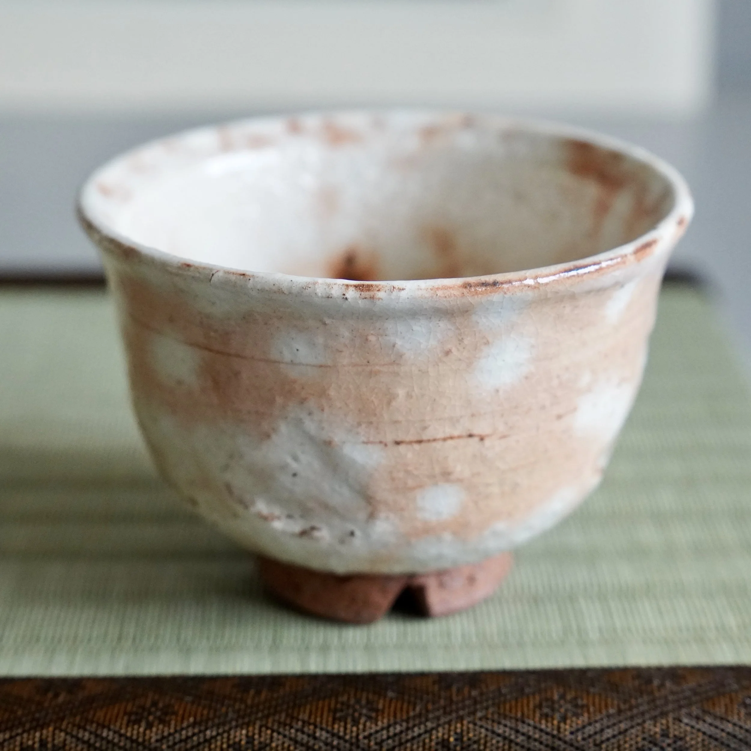 Interior of shira-hagi Hagi ware yunomi, Taizan kiln Japan, white rice straw ash glaze with orange tones and fine kannyu crazing throughout