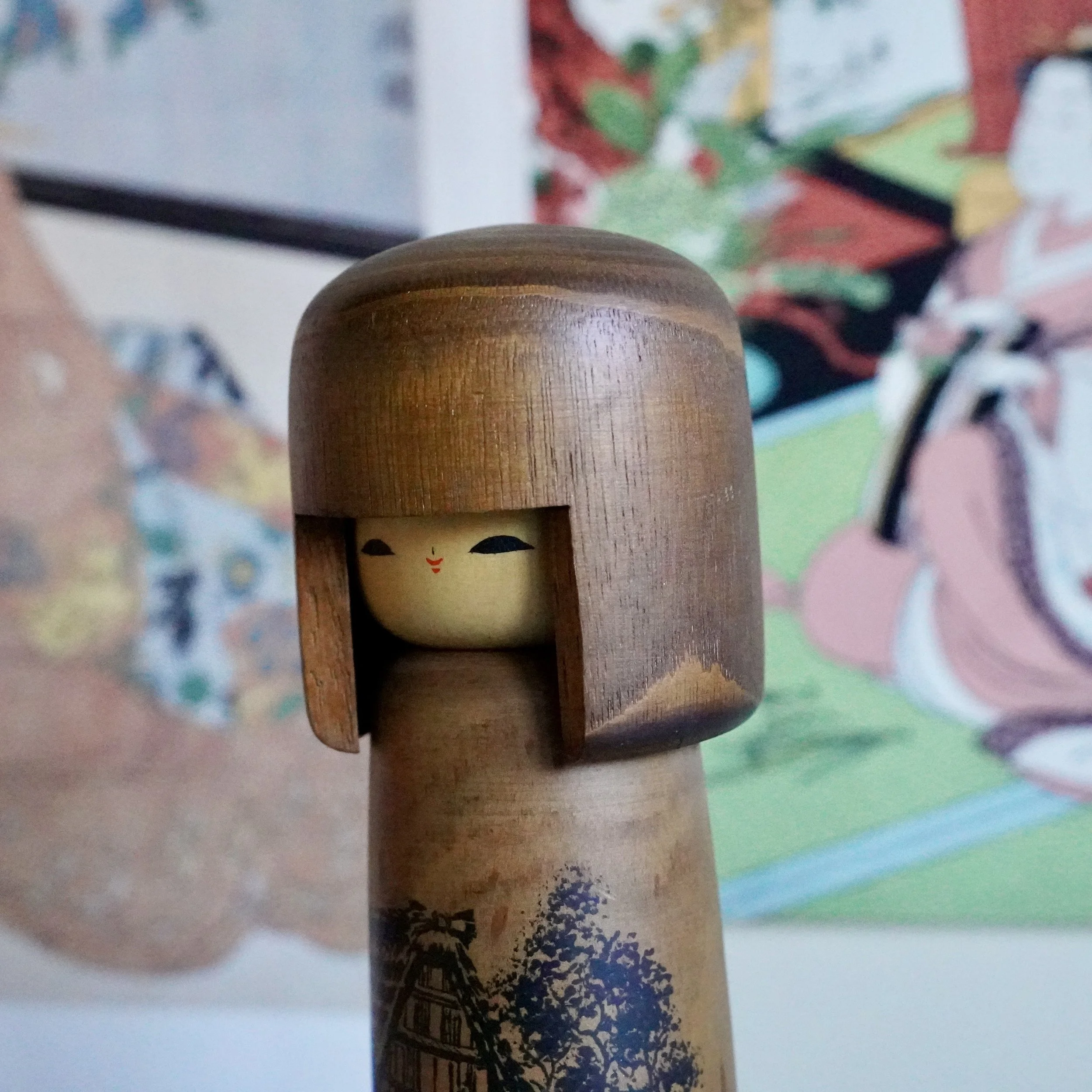 Sōsaku kokeshi doll by Usaburō, angled view of painted Hida road scene
