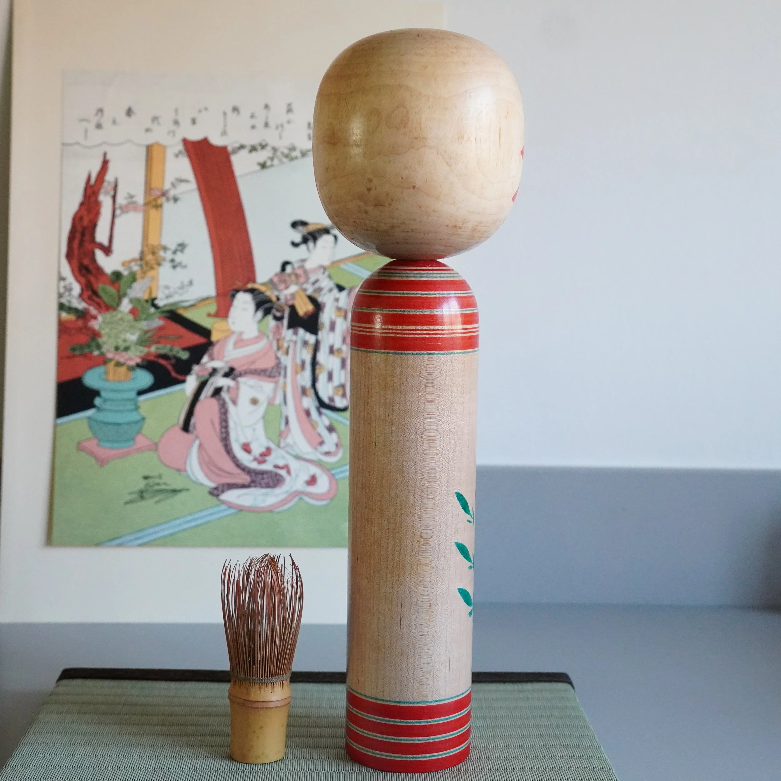 Yamagata kokeshi by Takasaki Eiichirō, rear view, natural unpainted wood back, red lathe-turned banding stripes at neck and base, Shōwa period Japan