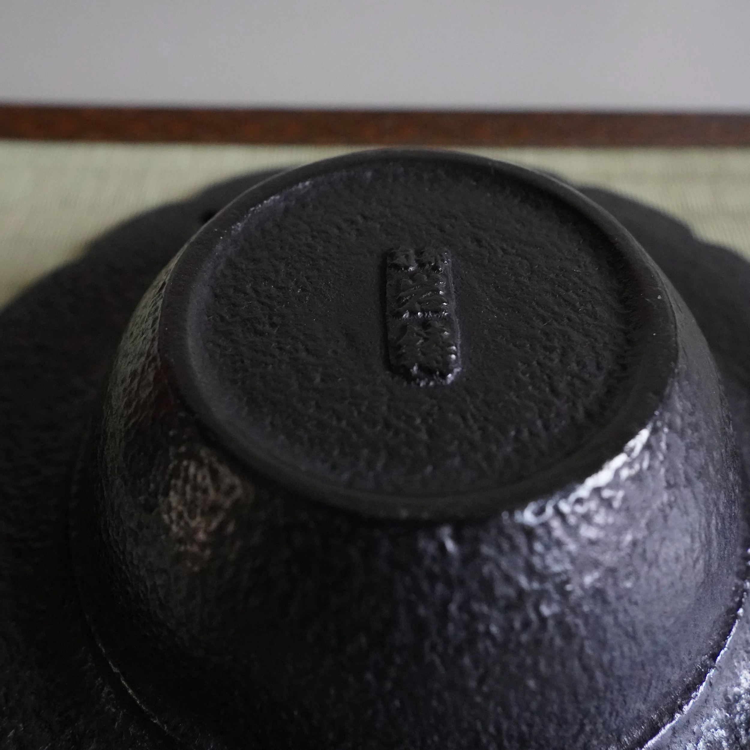 Base of a Nanbu Tekki cast iron kōro showing the maker's cast seal mark