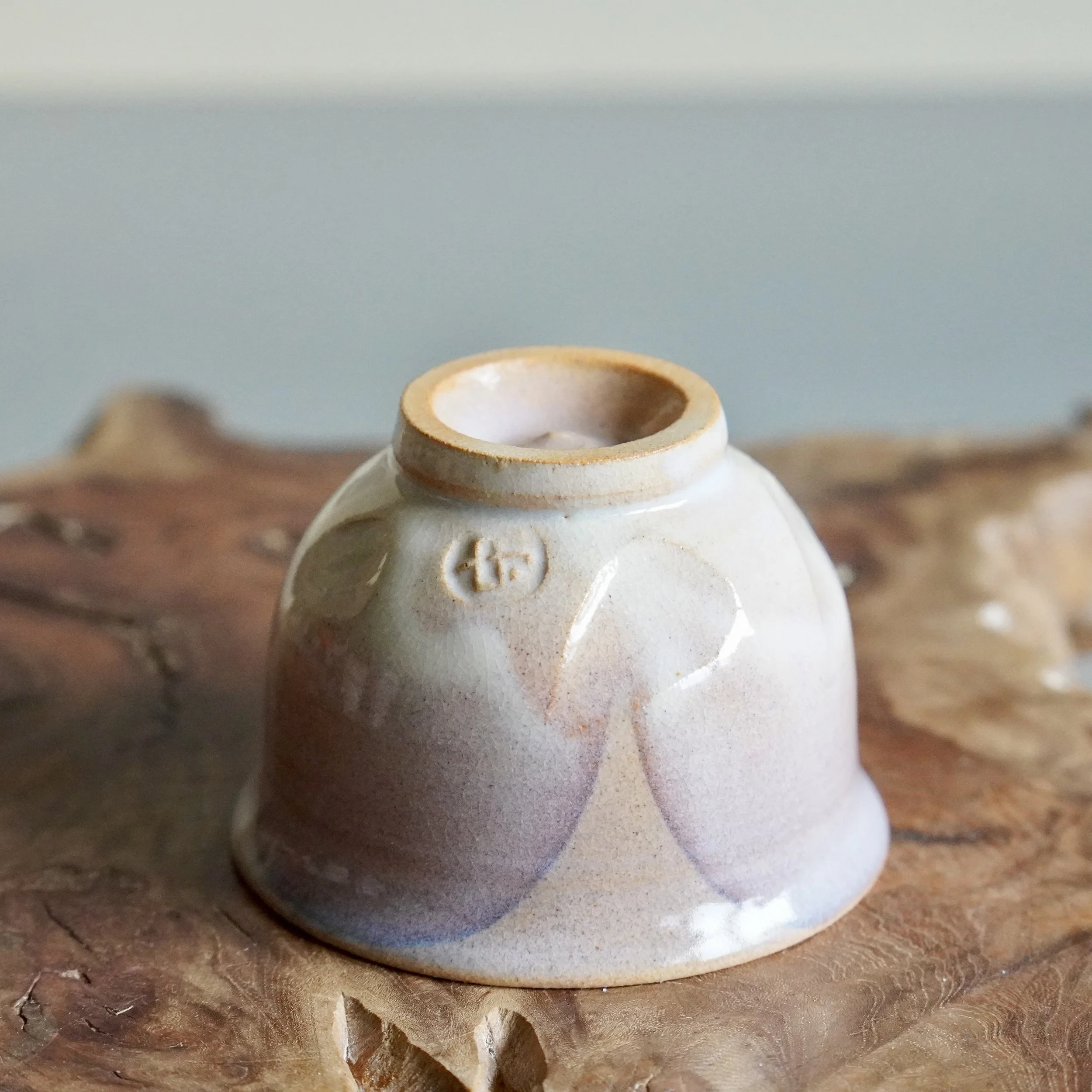 Hagi-yaki yunomi cup close-up showing maker's seal and glaze crackle