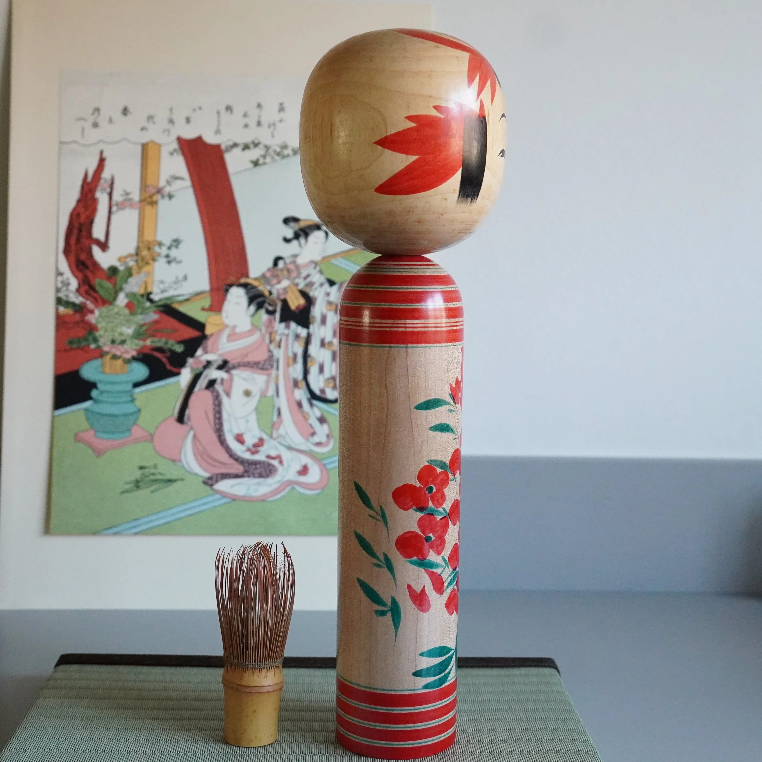 Yamagata-kei kokeshi Takasaki Eiichirō, angled front view showing full proportions, hand-painted chrysanthemum and red banding, Shōwa period traditional Japanese wooden doll