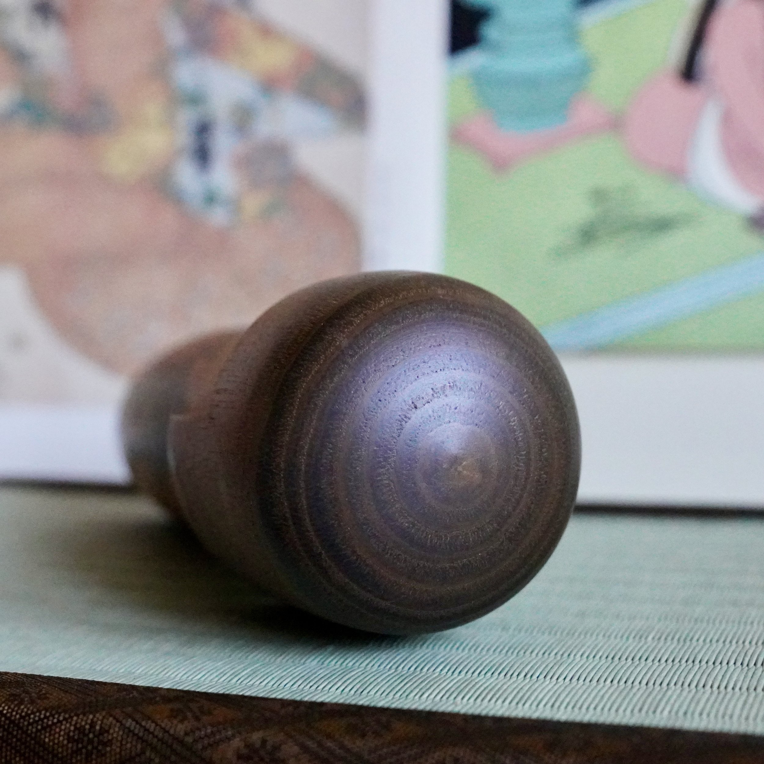 Head detail of Usaburō sōsaku kokeshi doll showing turned wood grain
