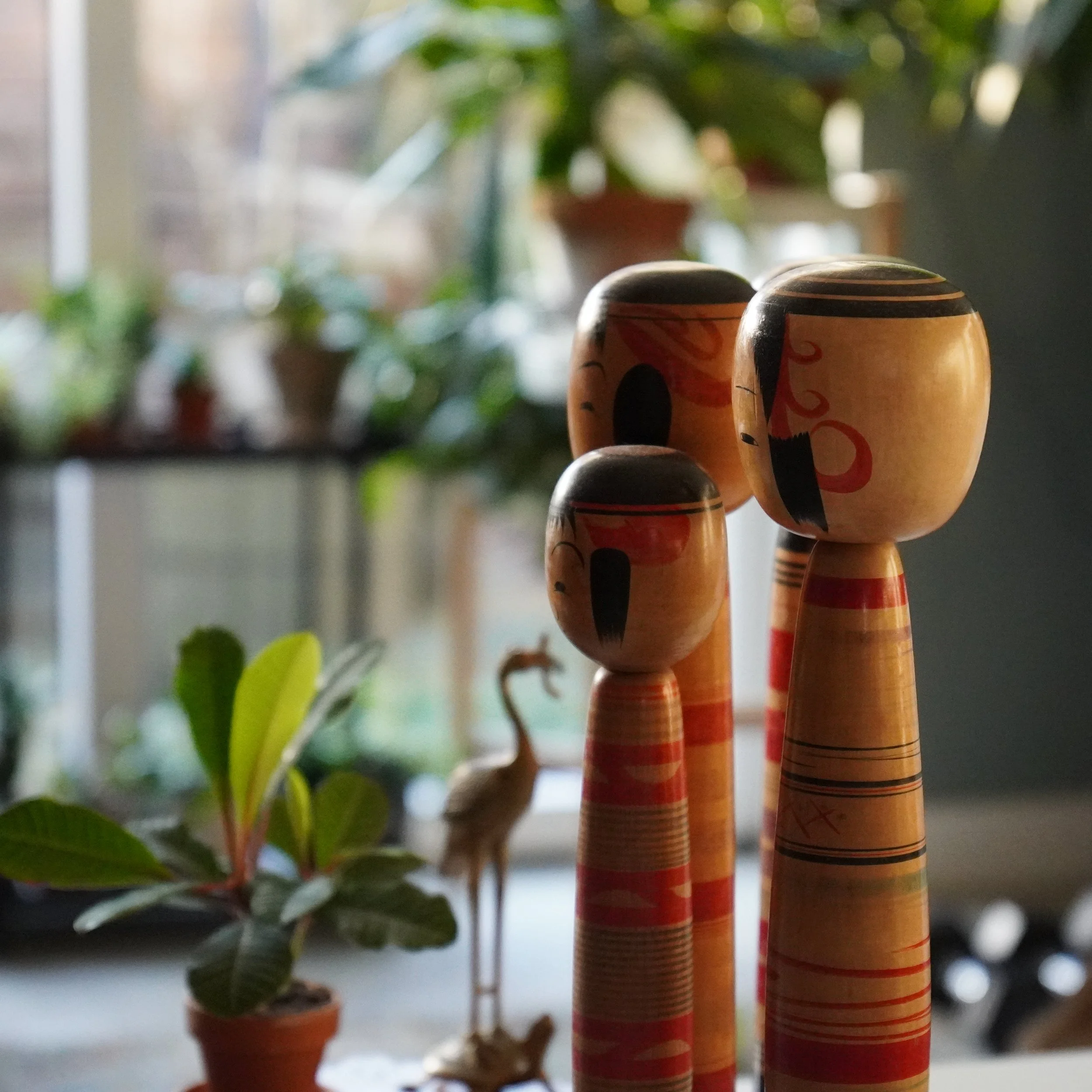 Traditional Tsuchiyu kokeshi by Abe Ichiro and Abe Kazue grouped together in a home setting, showing how a set of three works as a family arrangement