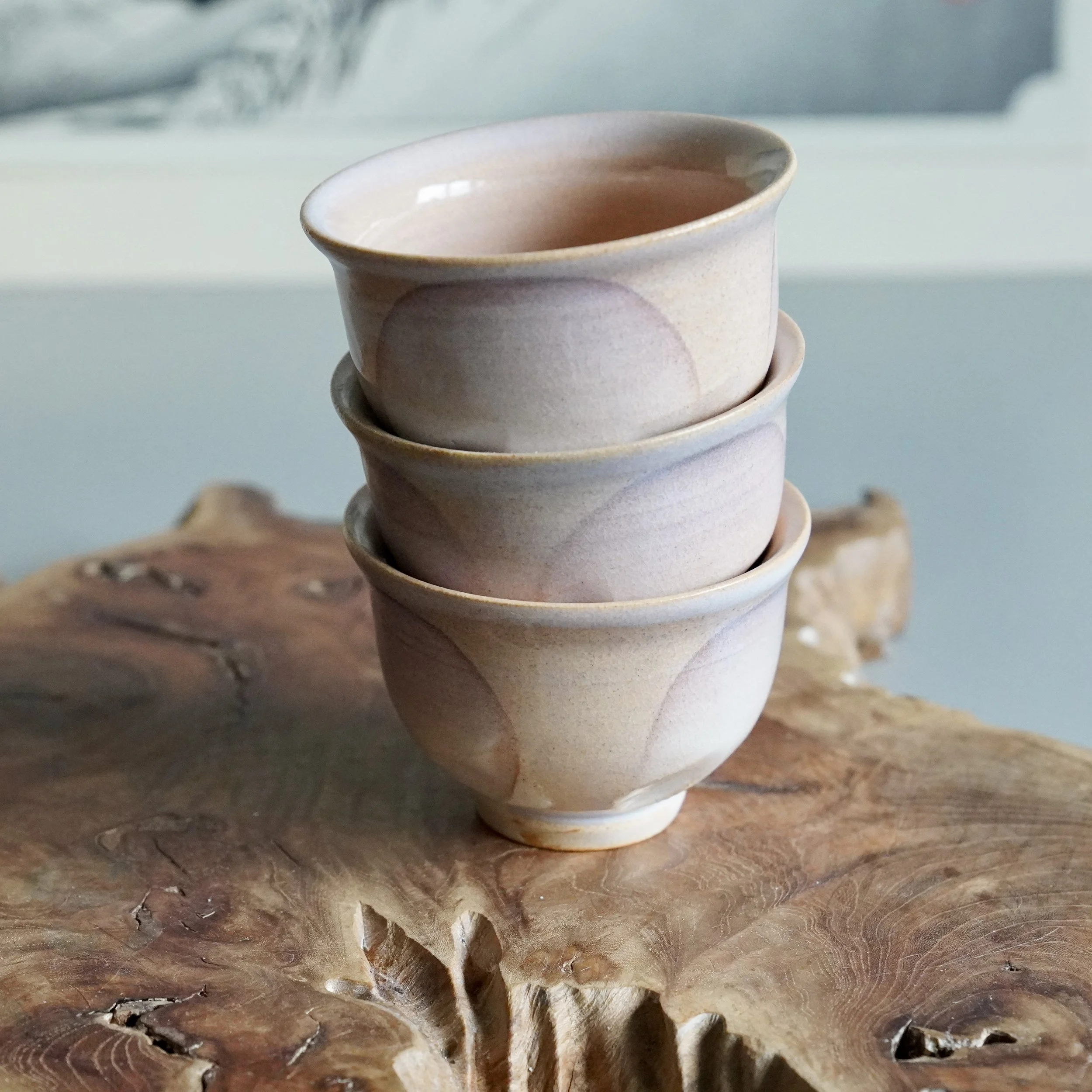 7. Three Hagi-yaki yunomi cups stacked, pearl white to lavender glaze