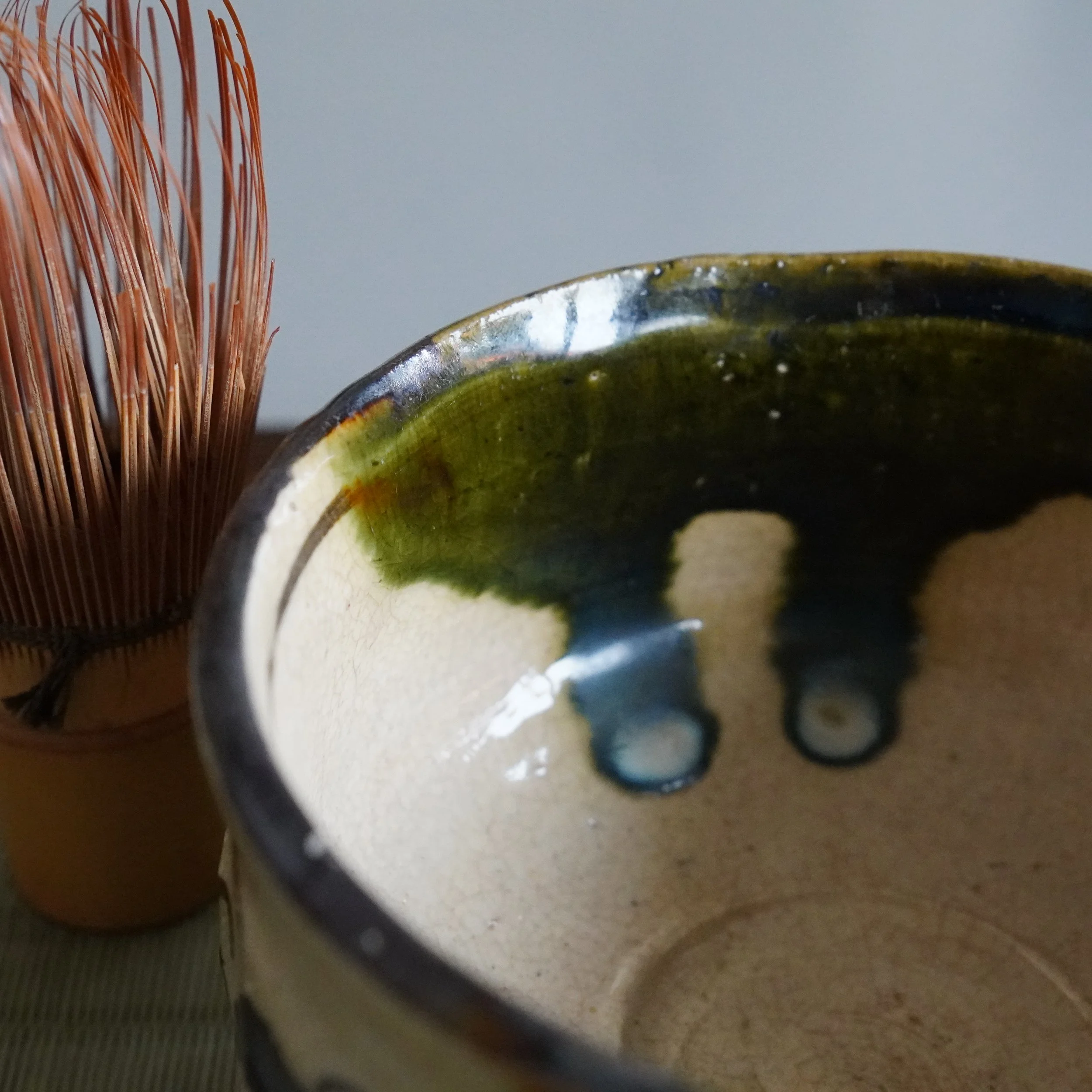 Ao-Oribe chawan interior glaze detail copper green shifting to deep teal where pooled thickest crackle pattern on stoneware Mino ware Gifu Prefecture Showa period