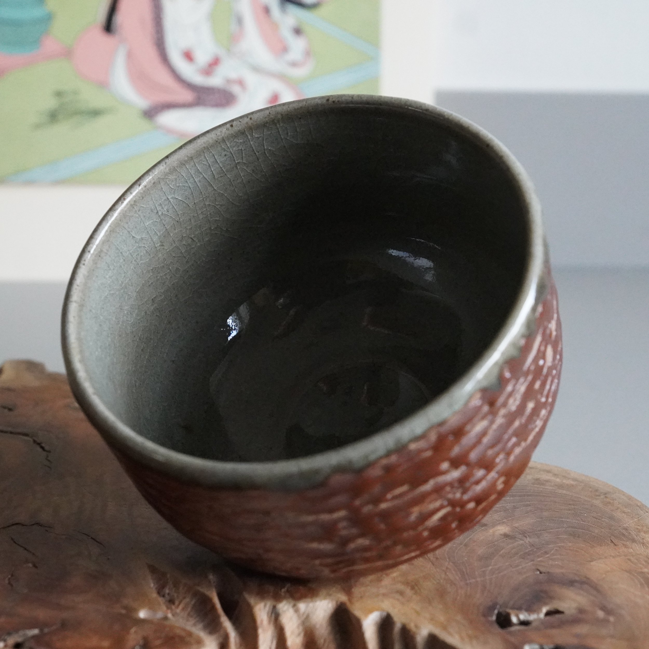 Top-down view of grey-green glazed interior, Inuyama-yaki chawan with bark-textured exterior