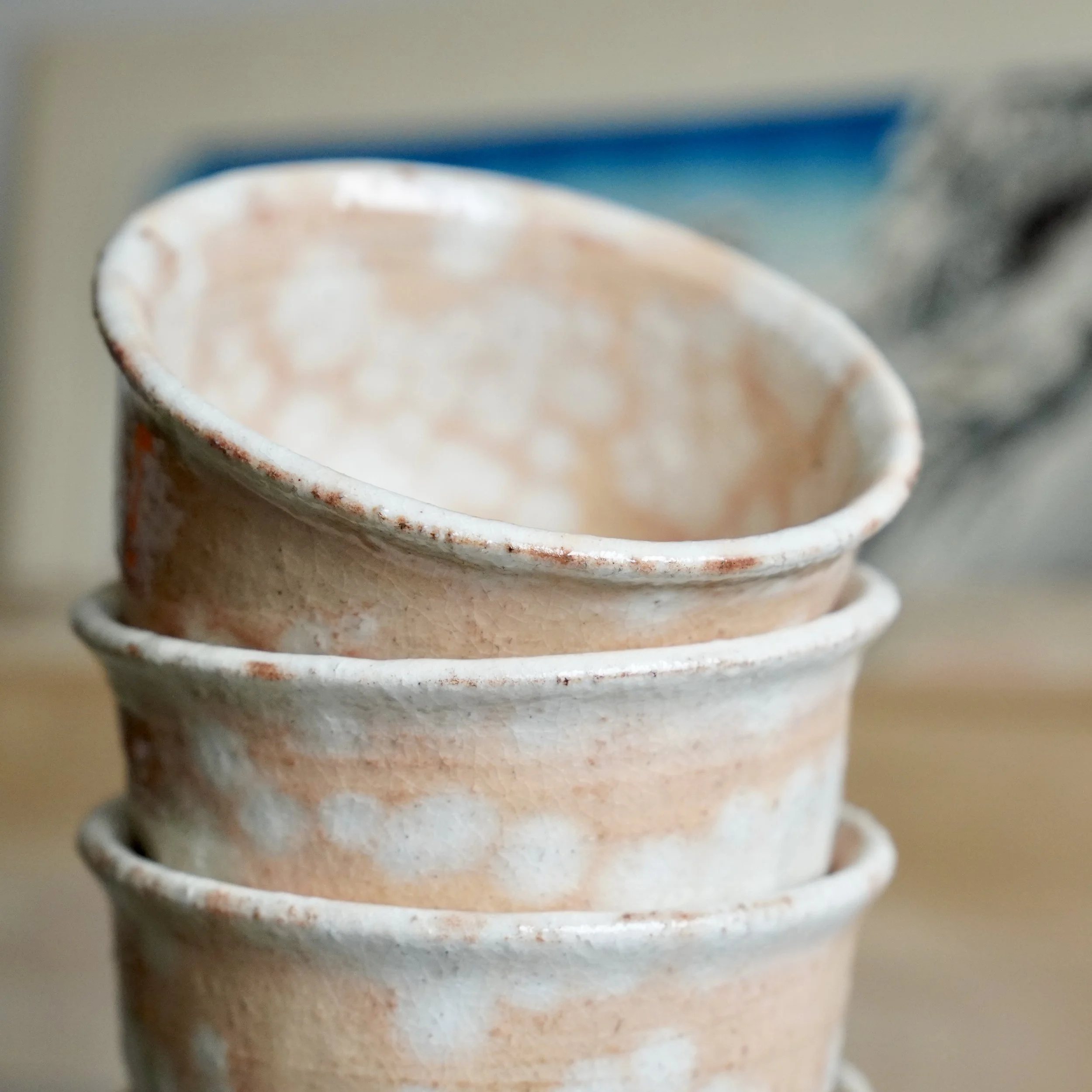 Five shira-hagi Hagi-yaki yunomi stacked showing white interior glaze and glaze variation, Taizan kiln Japan, vintage Japanese tea cups for sencha or gyokuro