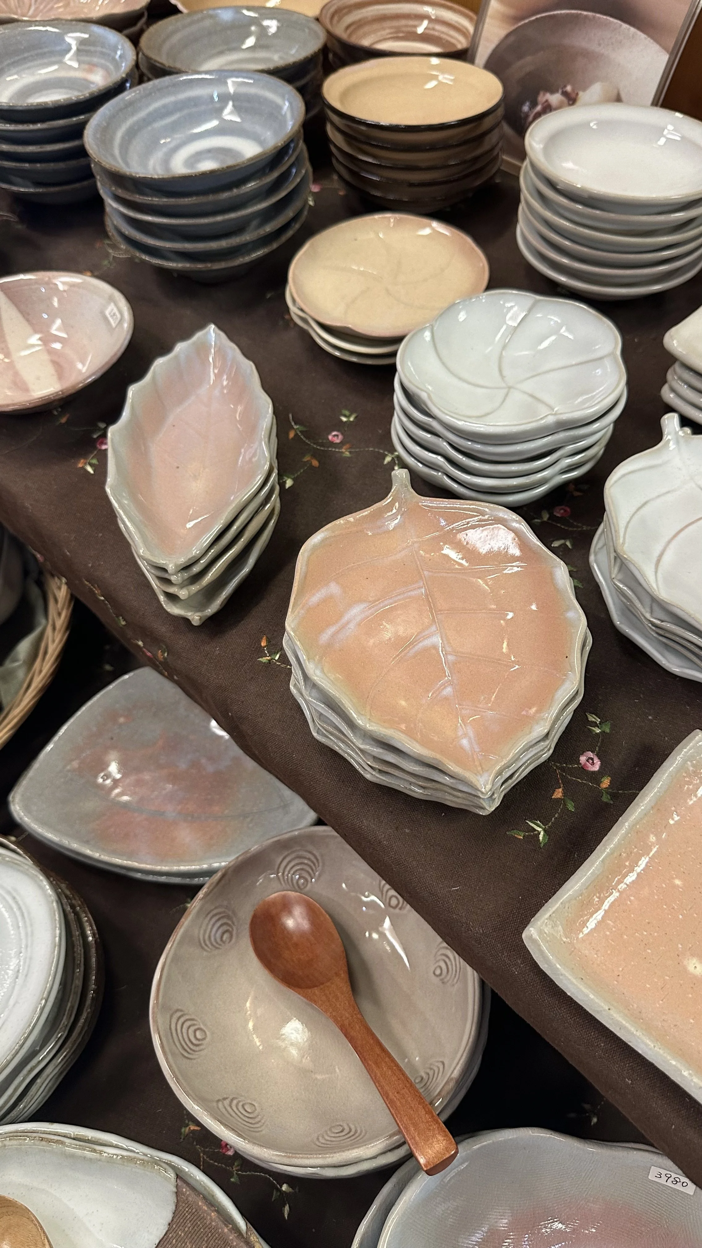 Leaf-shaped Hagi-yaki dishes in pink and grey glazes stacked in the Senryūzan shop, Hagi Japan