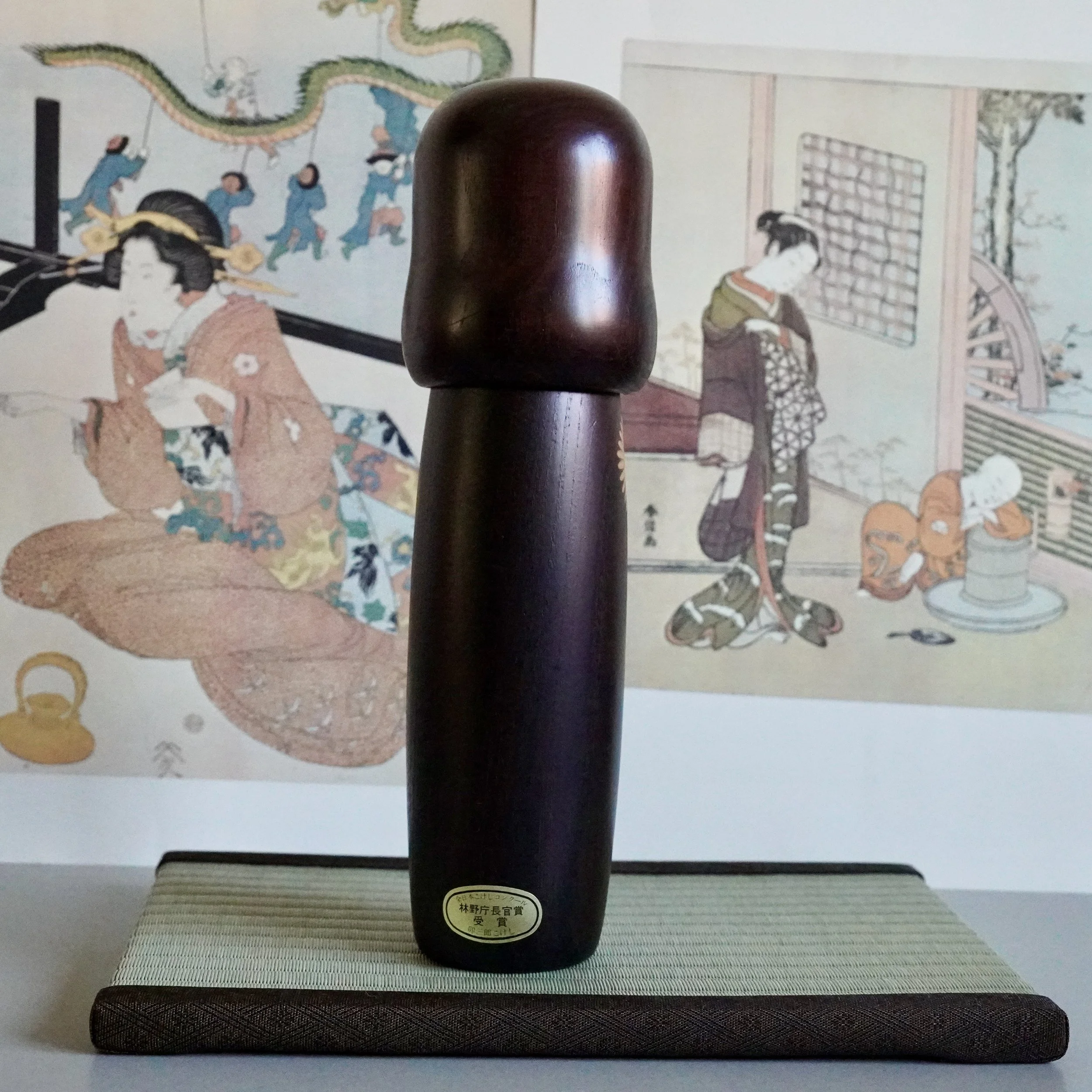 5. Usaburo sosaku kokeshi full back view, dark aubergine wood, smooth rounded silhouette, Showa period