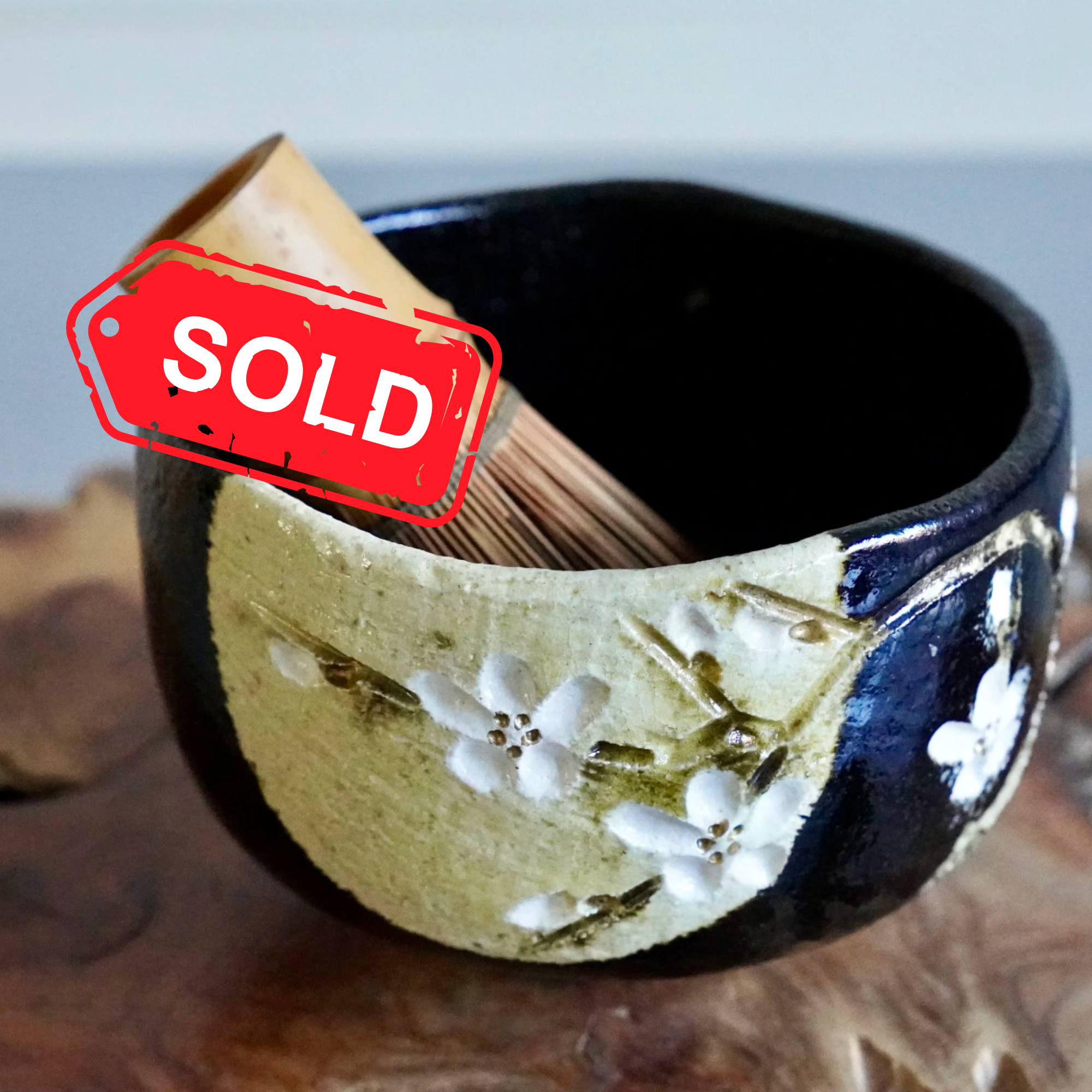 (sold) Kuro chawan with carved cherry blossom, signed by Okugawa Katsuomi with tomobako, late Shōwa period