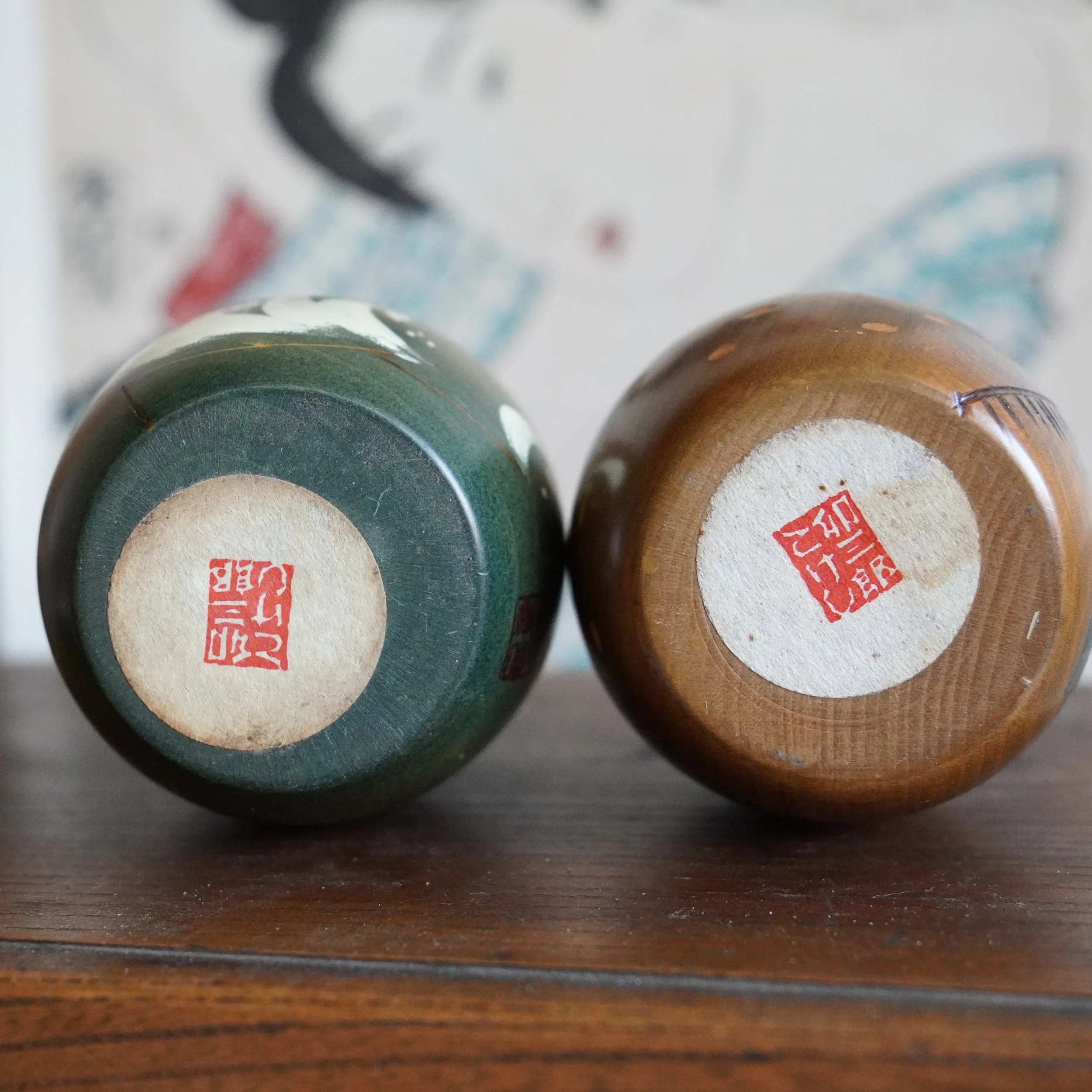 Base view of vintage Usaburo kokeshi pair showing red maker seals, Shiki no Uta series, Showa period Gunma