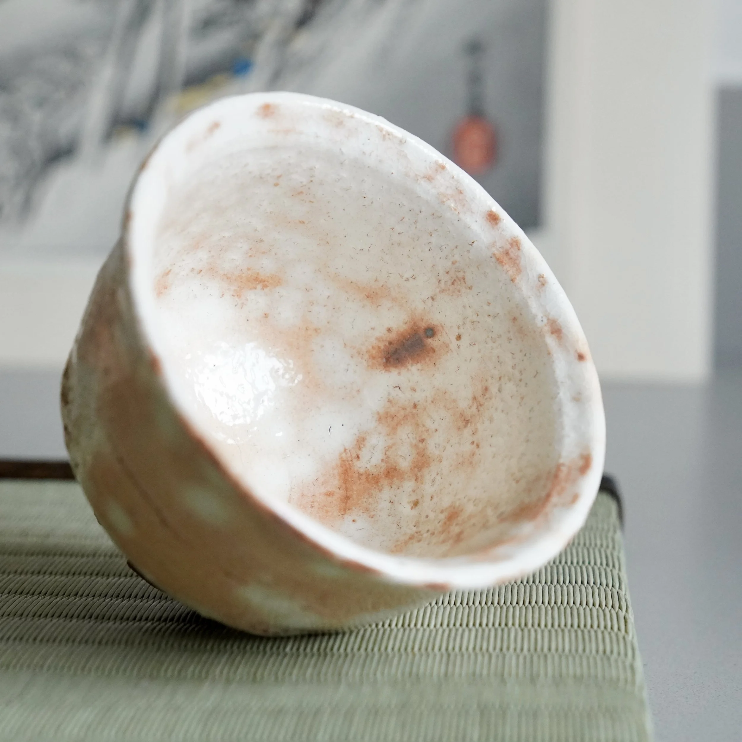 Interior close-up of shira-hagi Hagi ware yunomi, Taizan kiln Japan, soft white glaze with warm undertone and fine crazing visible at the base