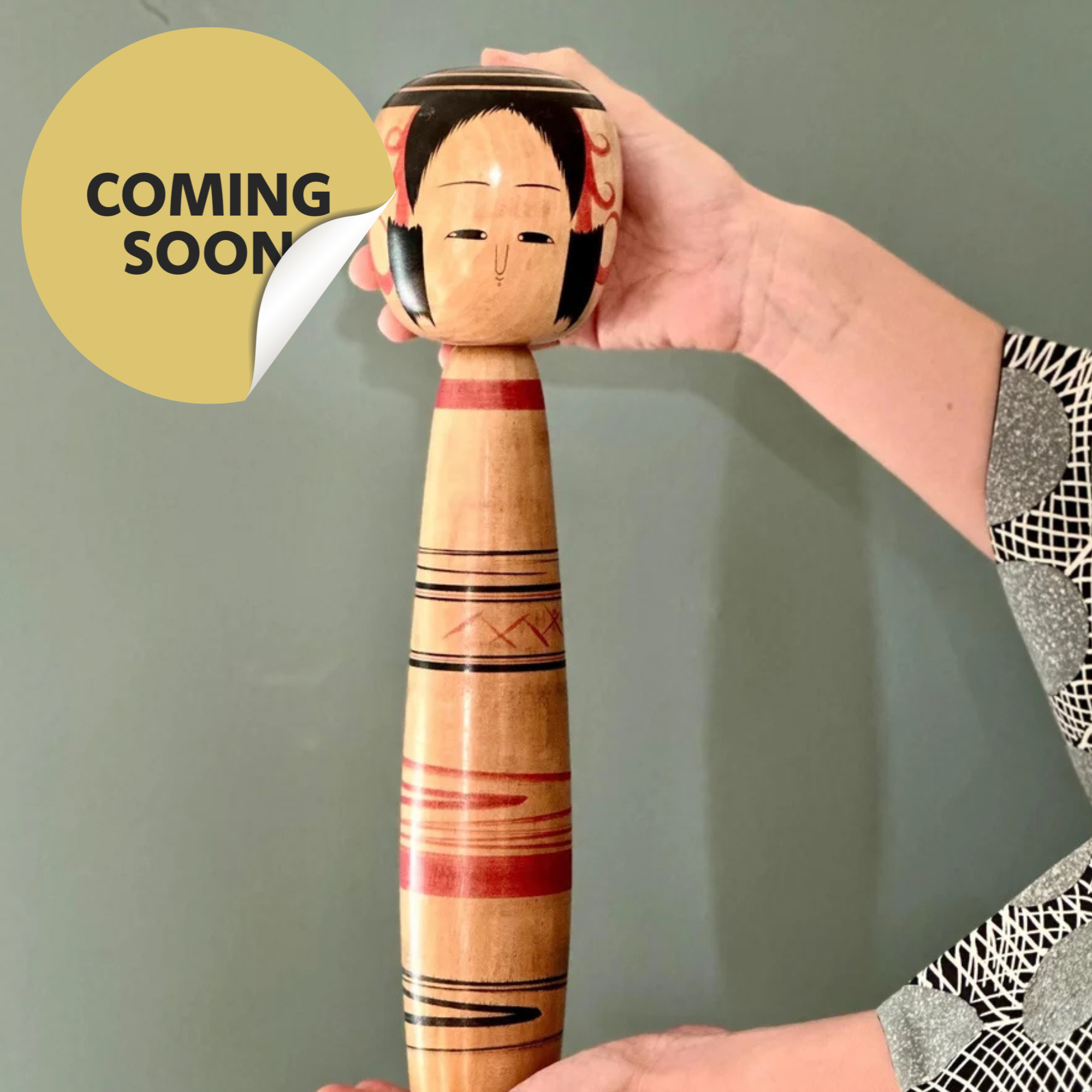 Large Tsuchiyu-style kokeshi Abe Ichirō XL hand-painted traditional banding decoration, signed, Shōwa period Japan, held in two hands wearing haori