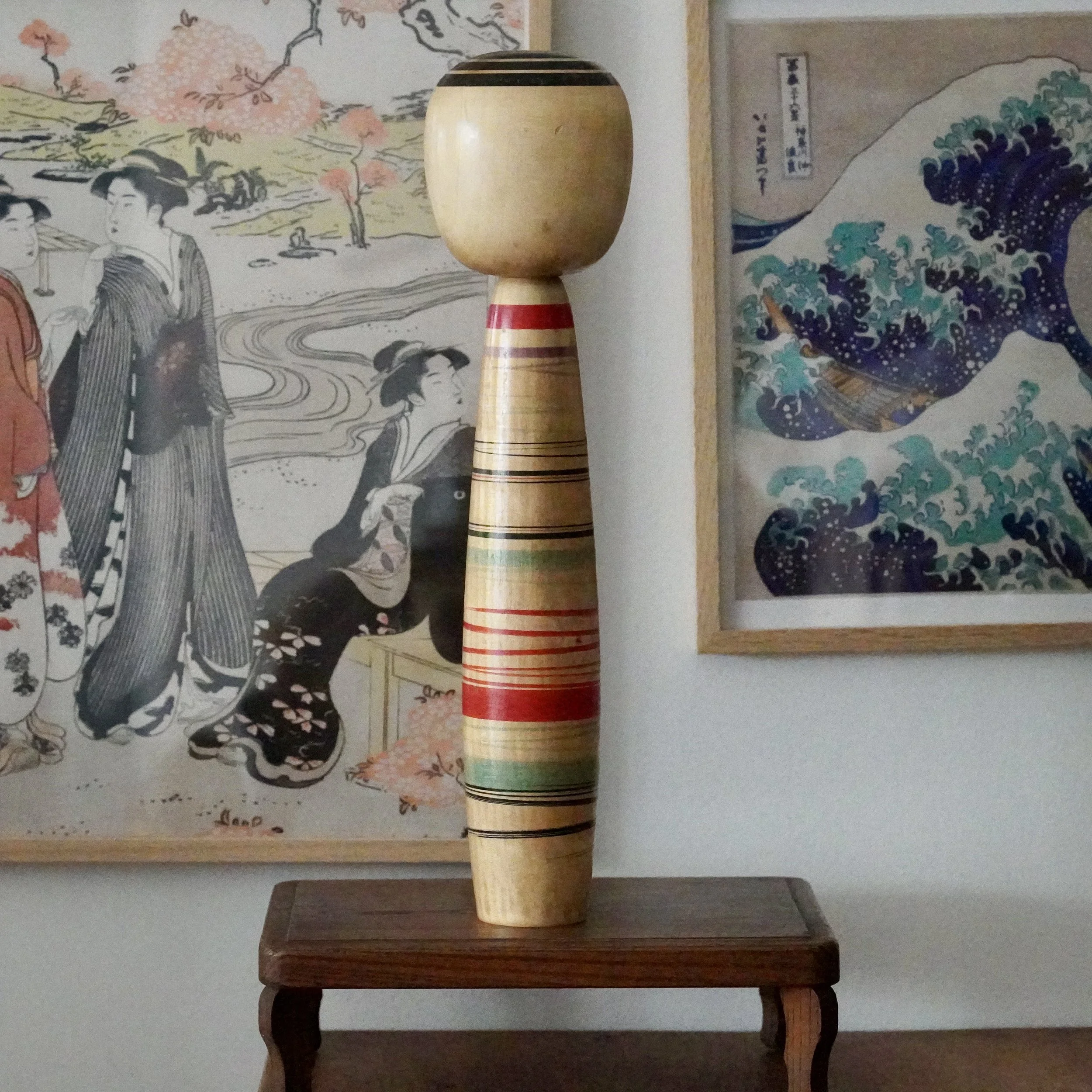 Tsuchiyu kokeshi by Abe Kazue seen from behind, red and black striping