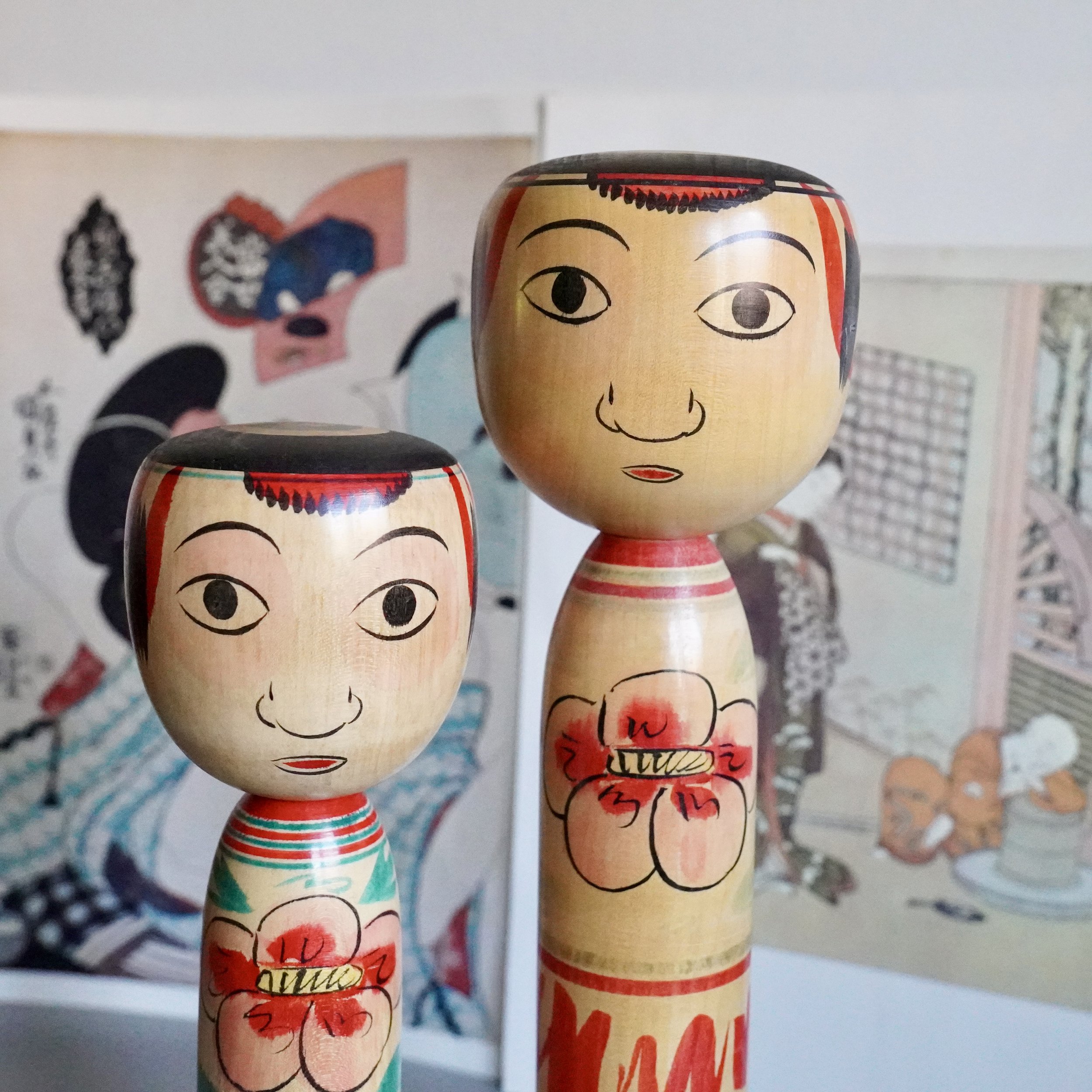 Nakanosawa Takobozu kokeshi pair by Saito Tokuju, signed vintage Japanese wooden dolls with red rimmed eyes and peony body decoration