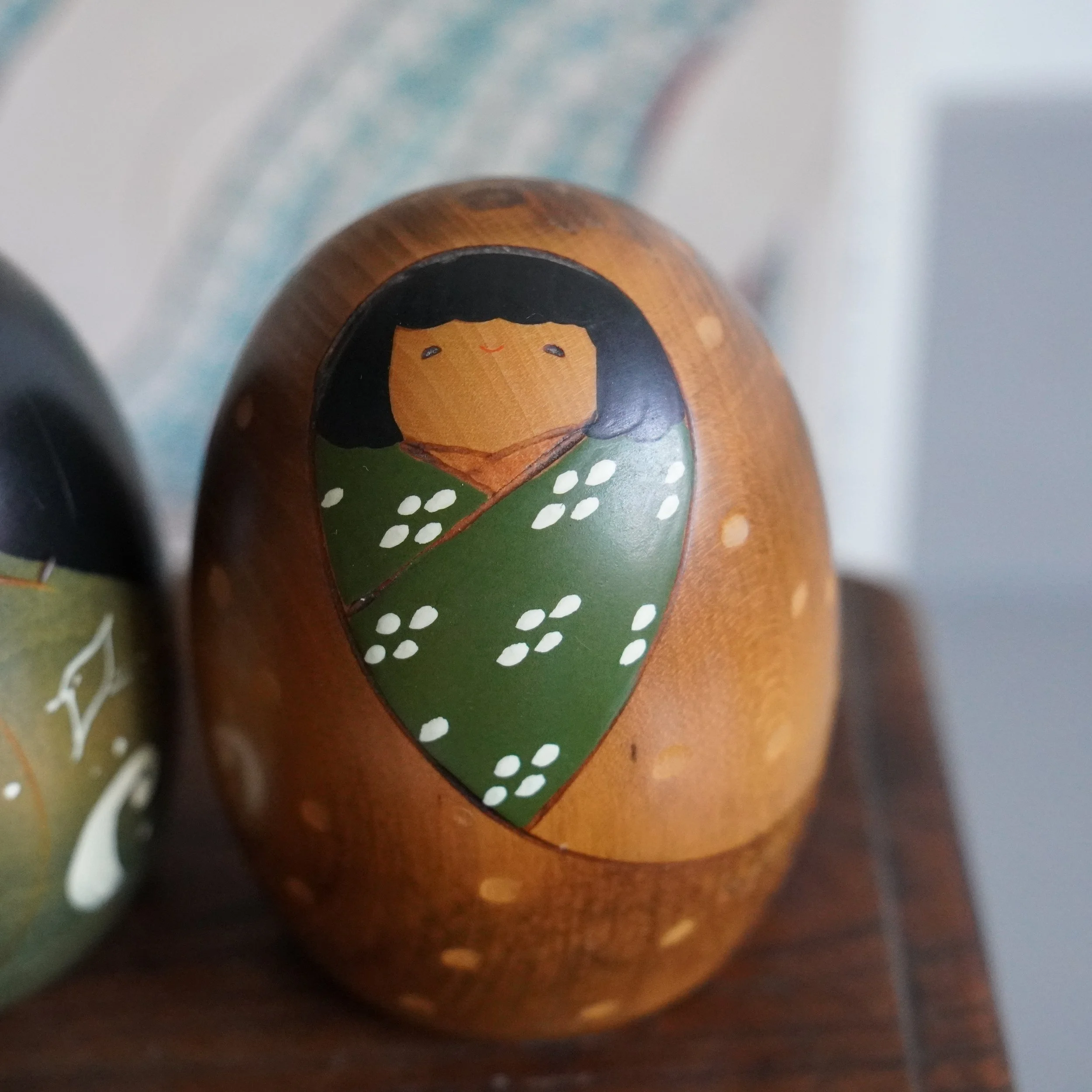 Close up of vintage Usaburo kokeshi winter doll, hand painted snow dot motif, Shiki no Uta series, Showa period