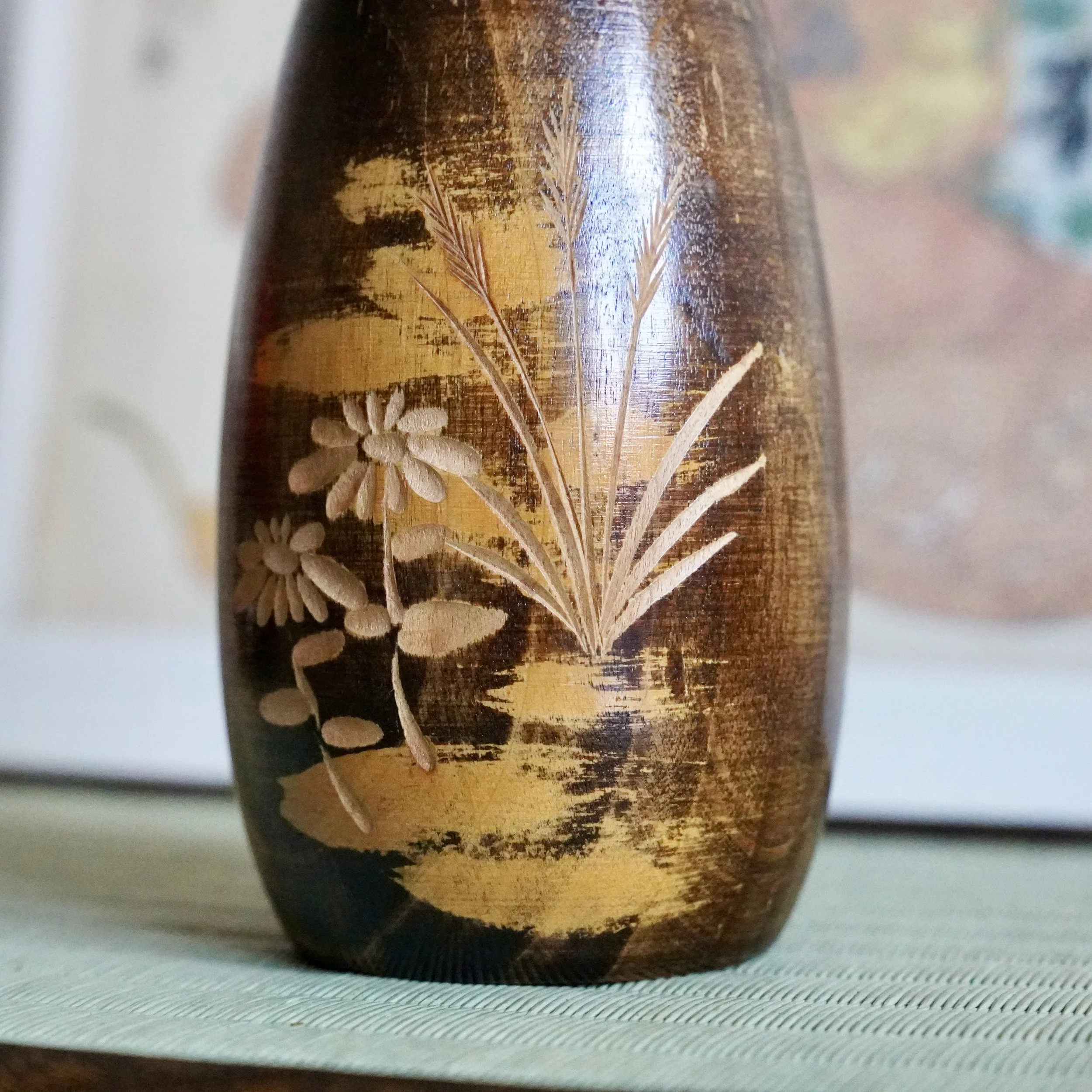 carved chrysanthemum and autumn grasses relief on lacquered kokeshi body