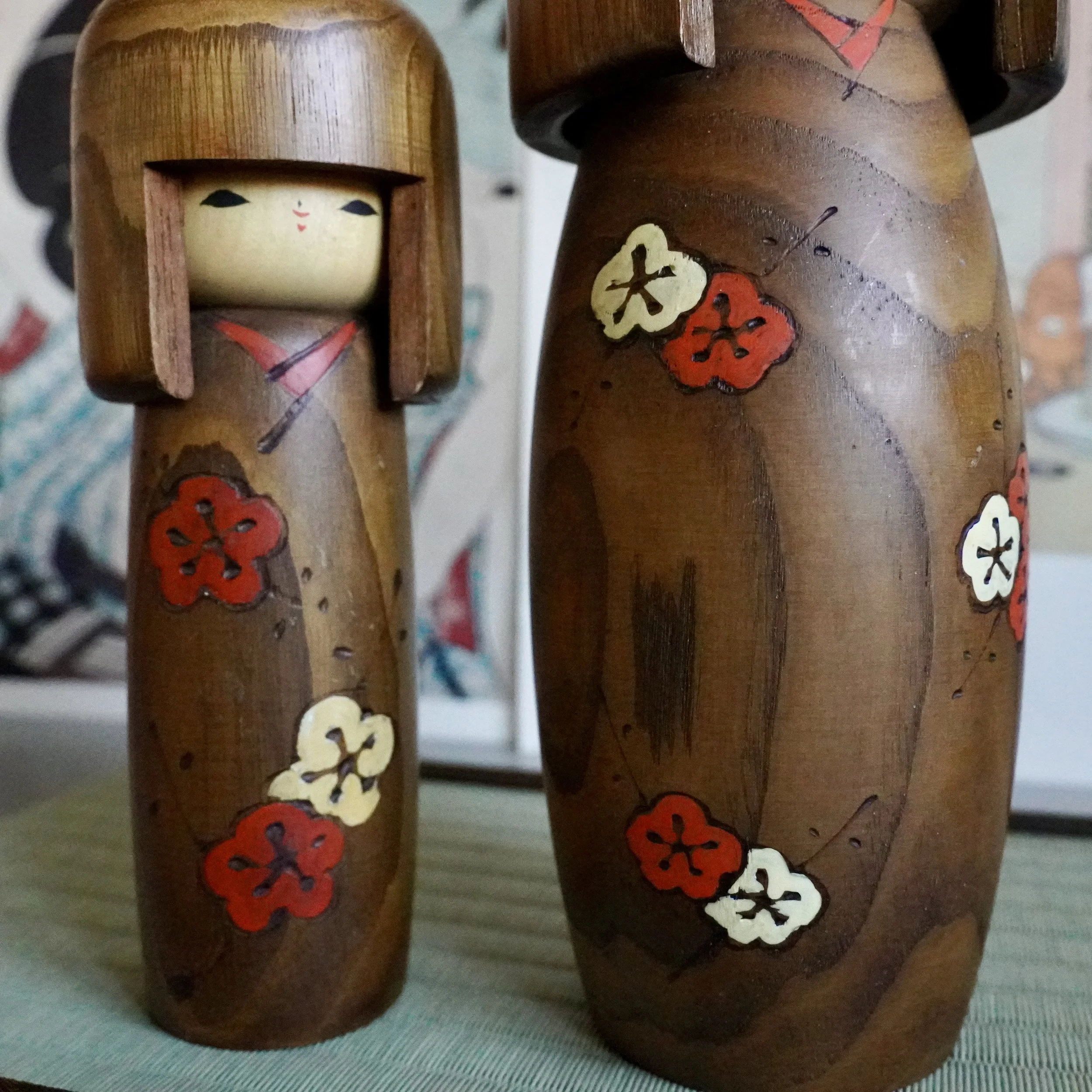 Usaburo kokeshi pair natural wood hair faces close together detail
