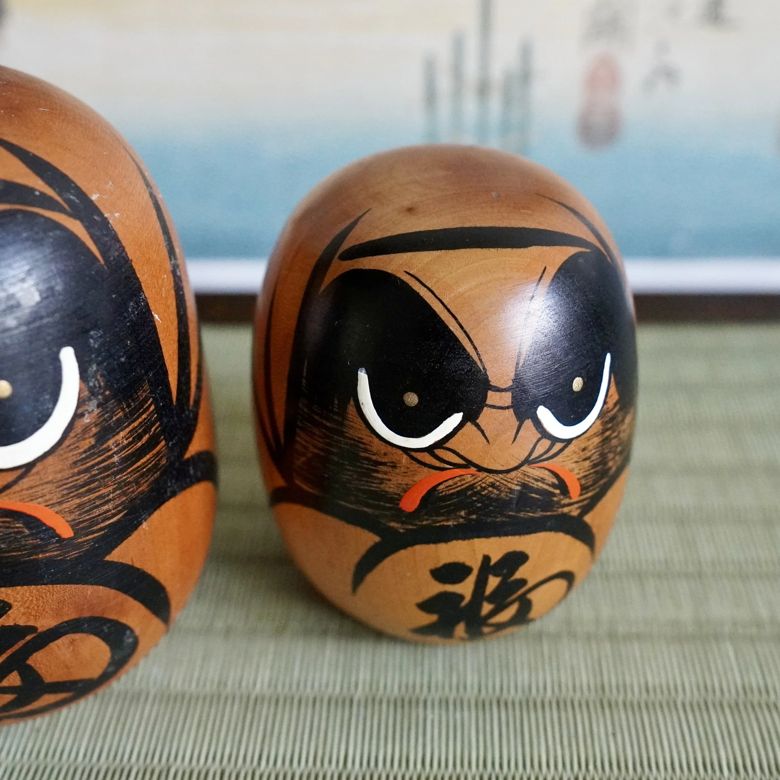 Vintage wooden daruma pair together, hand painted expressions, fuku kanji, Japanese folk craft.