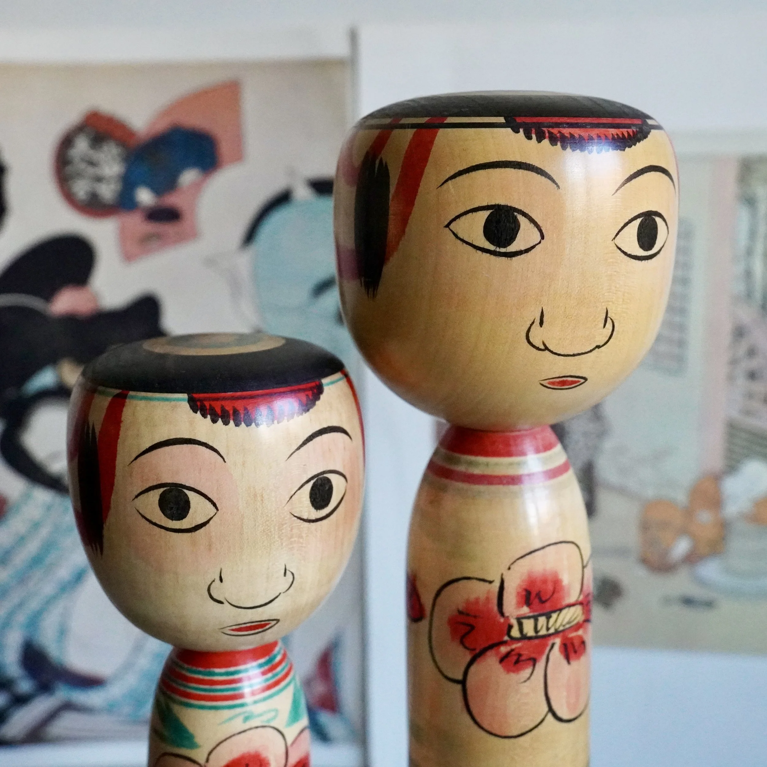 Nakanosawa Takobozu kokeshi pair, upper body and head view, peony decoration, signed vintage kokeshi by Saito Tokuju