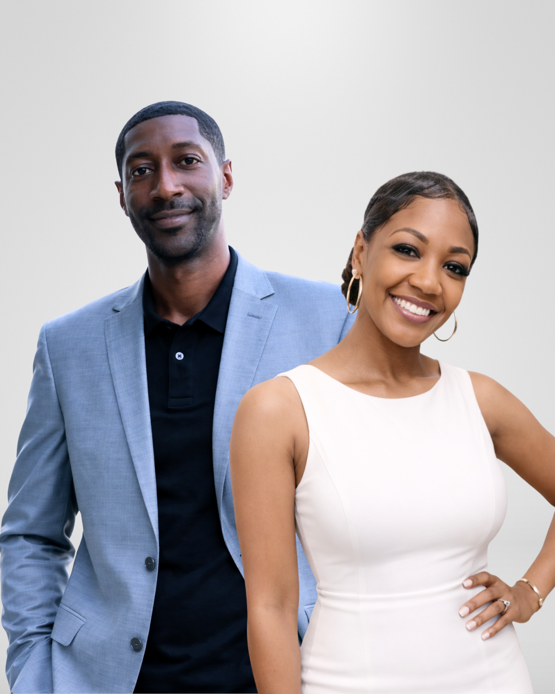 A smiling woman in a white sleeveless dress and a man in a gray suit jacket with a black shirt posing against a plain white background.