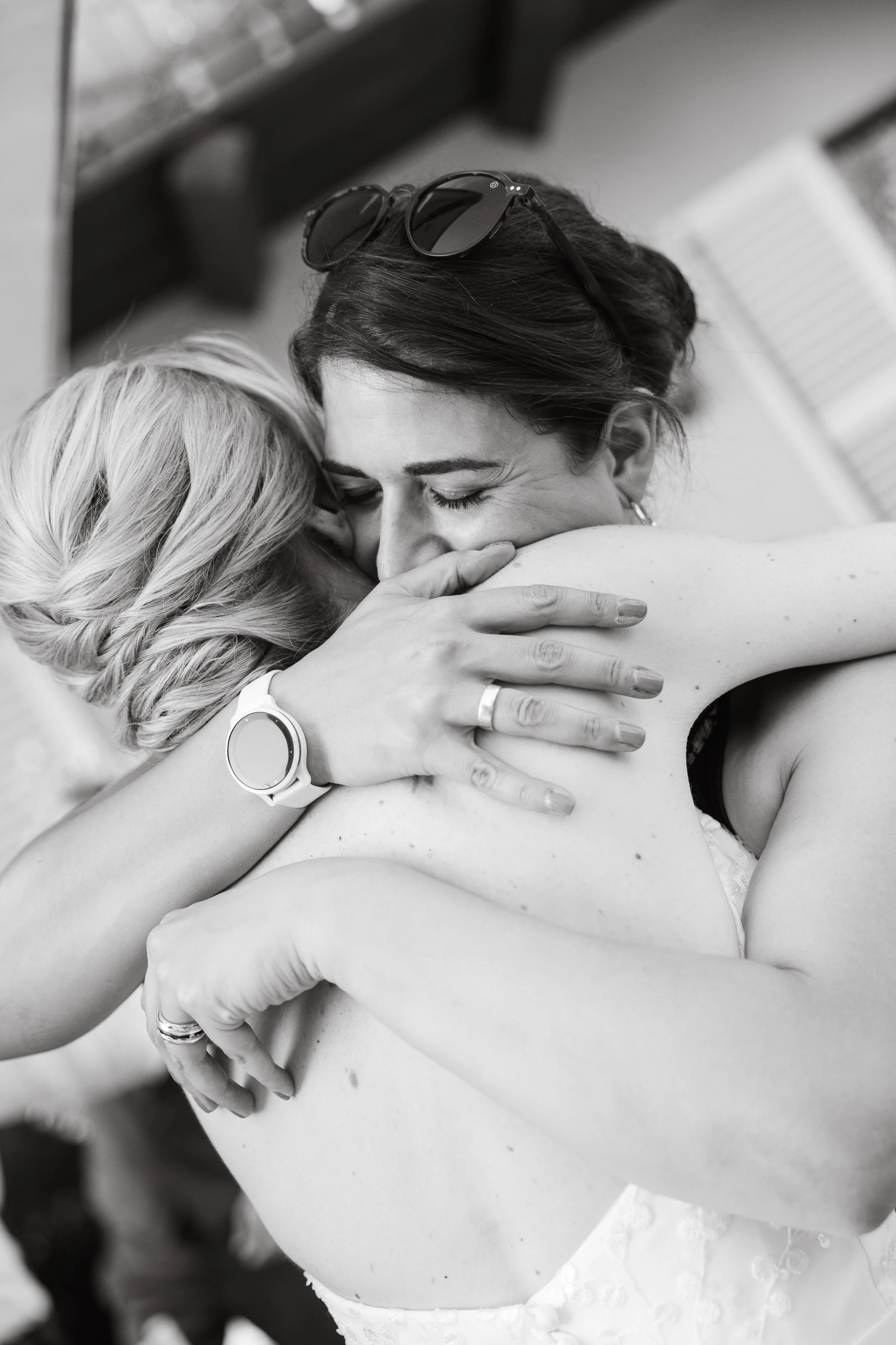 candid moment between bride and bridesmaid , editorial wedding photography at Corte Gondina, La morra , Langhe