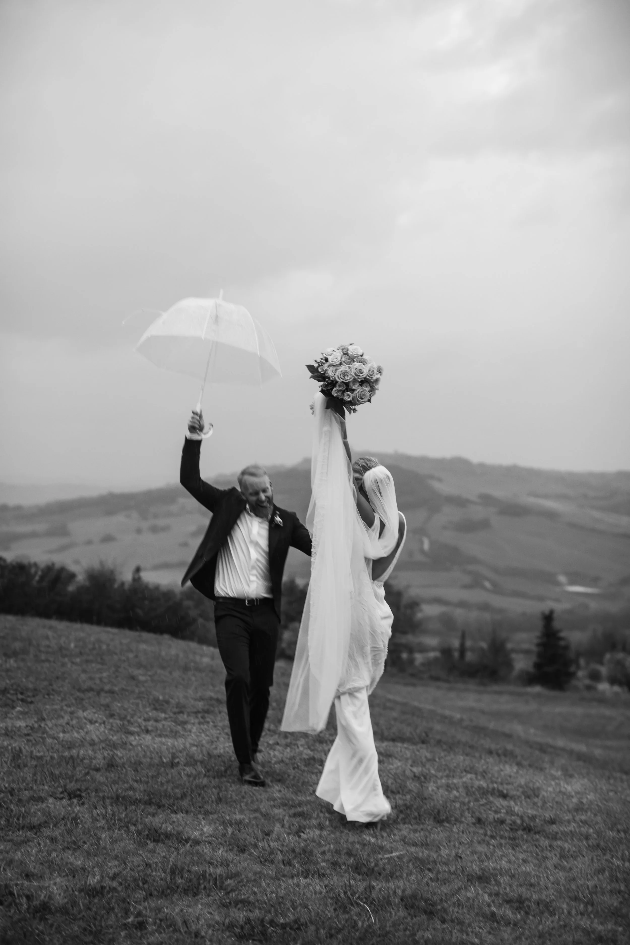 Spouses happy during a rainstorm at villa apparita. Intimate wedding.