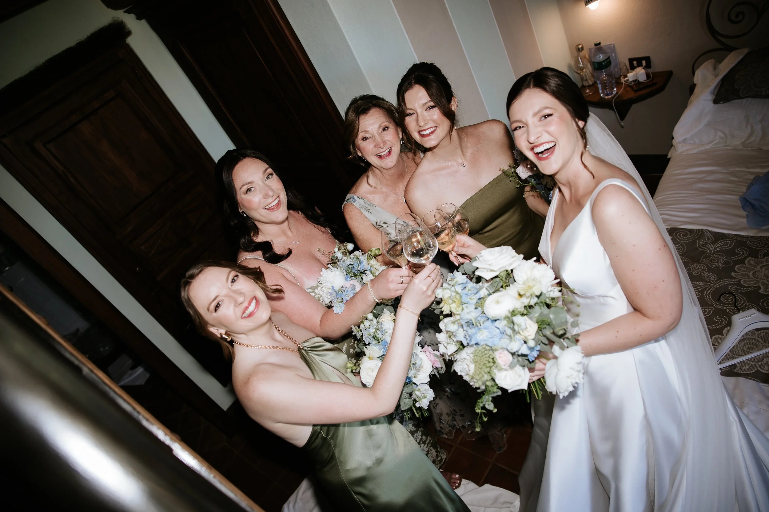 Bride and bridemaids celebrating with champagne before the ceremony.