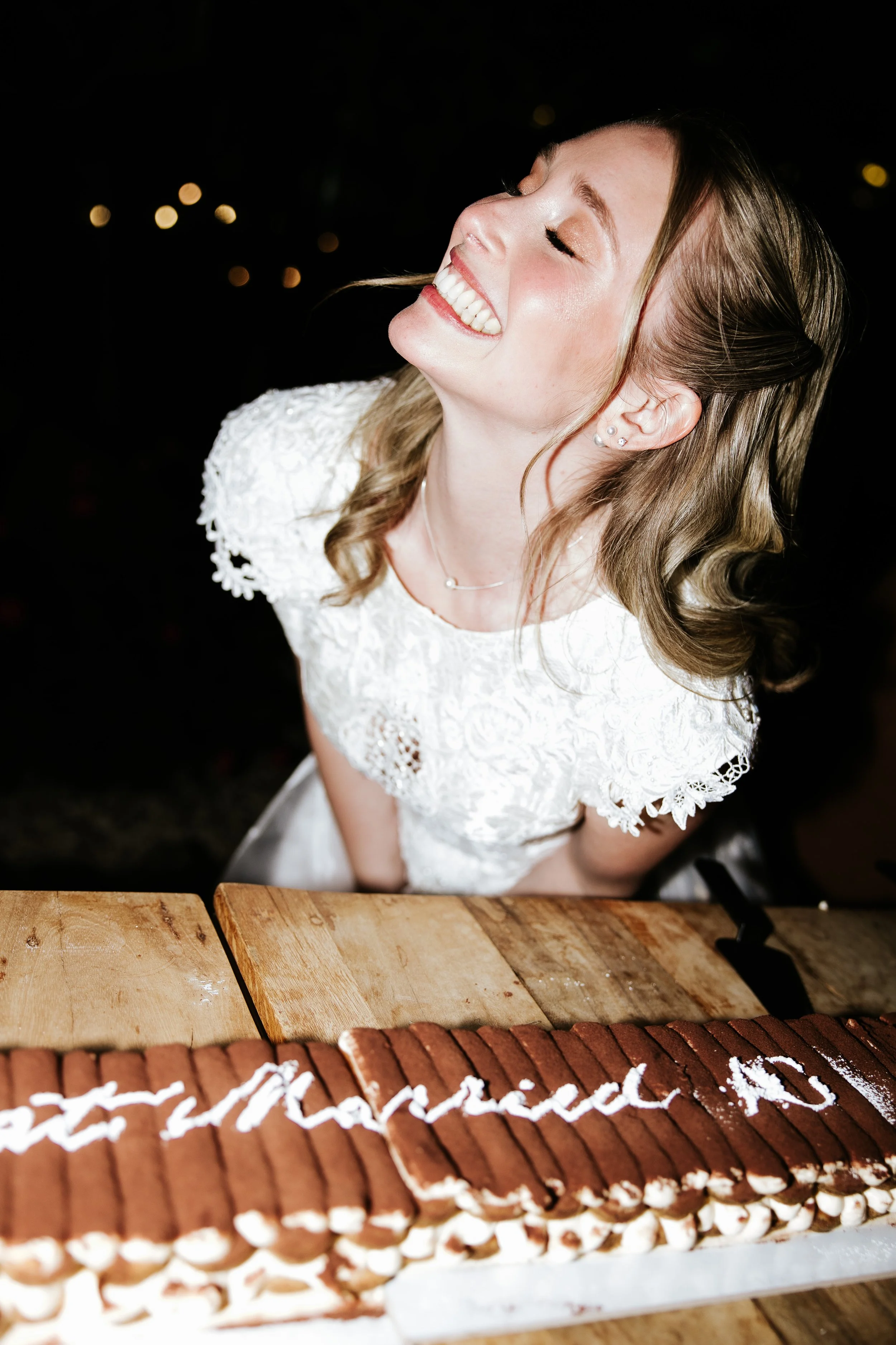 Bride during the wedding afterpary with the tiramisu cake smiling happy before the dance at Borgo Baccile , Abruzzo.