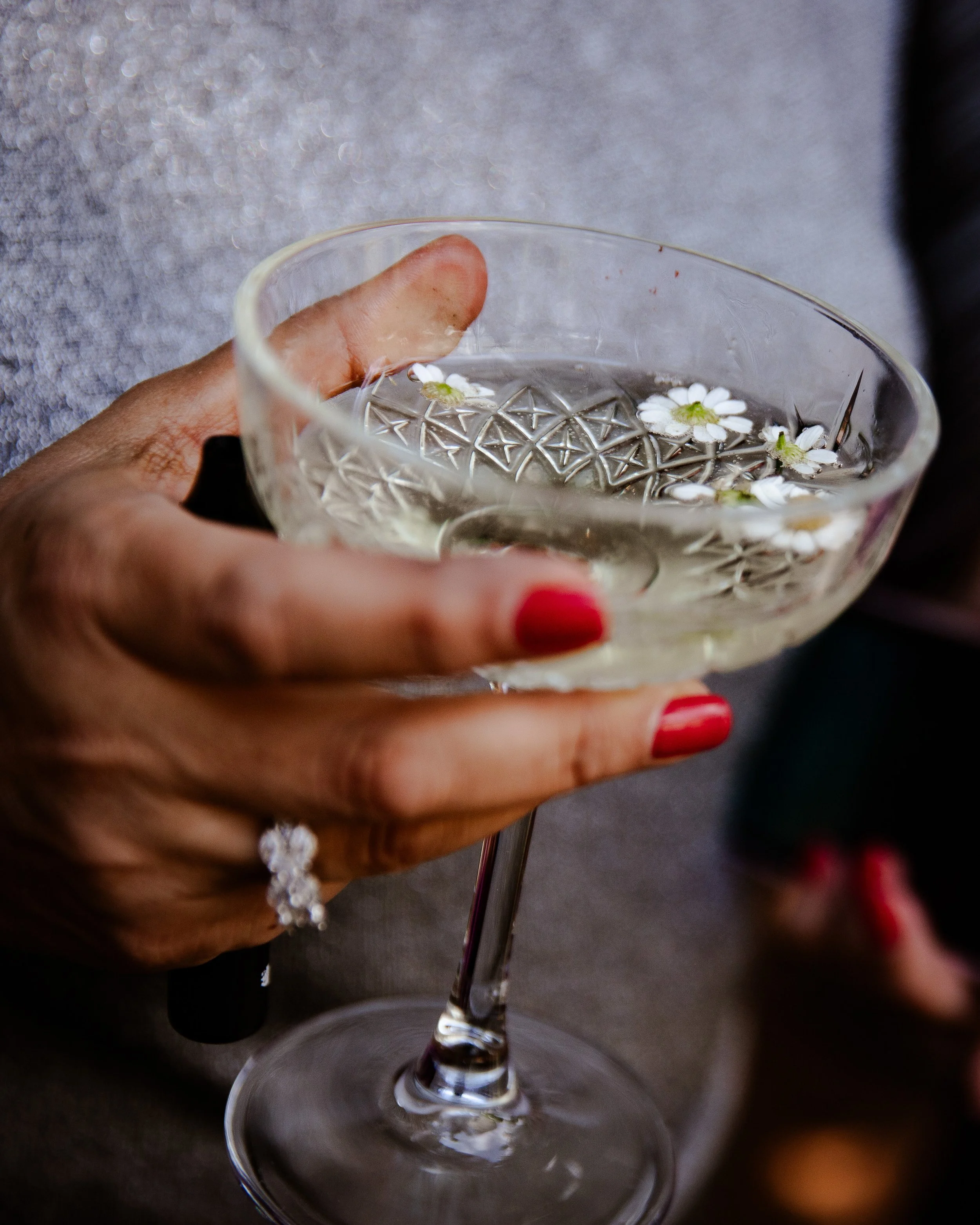 Cocktail detail at villa corsini, glass with champagne and flowers.