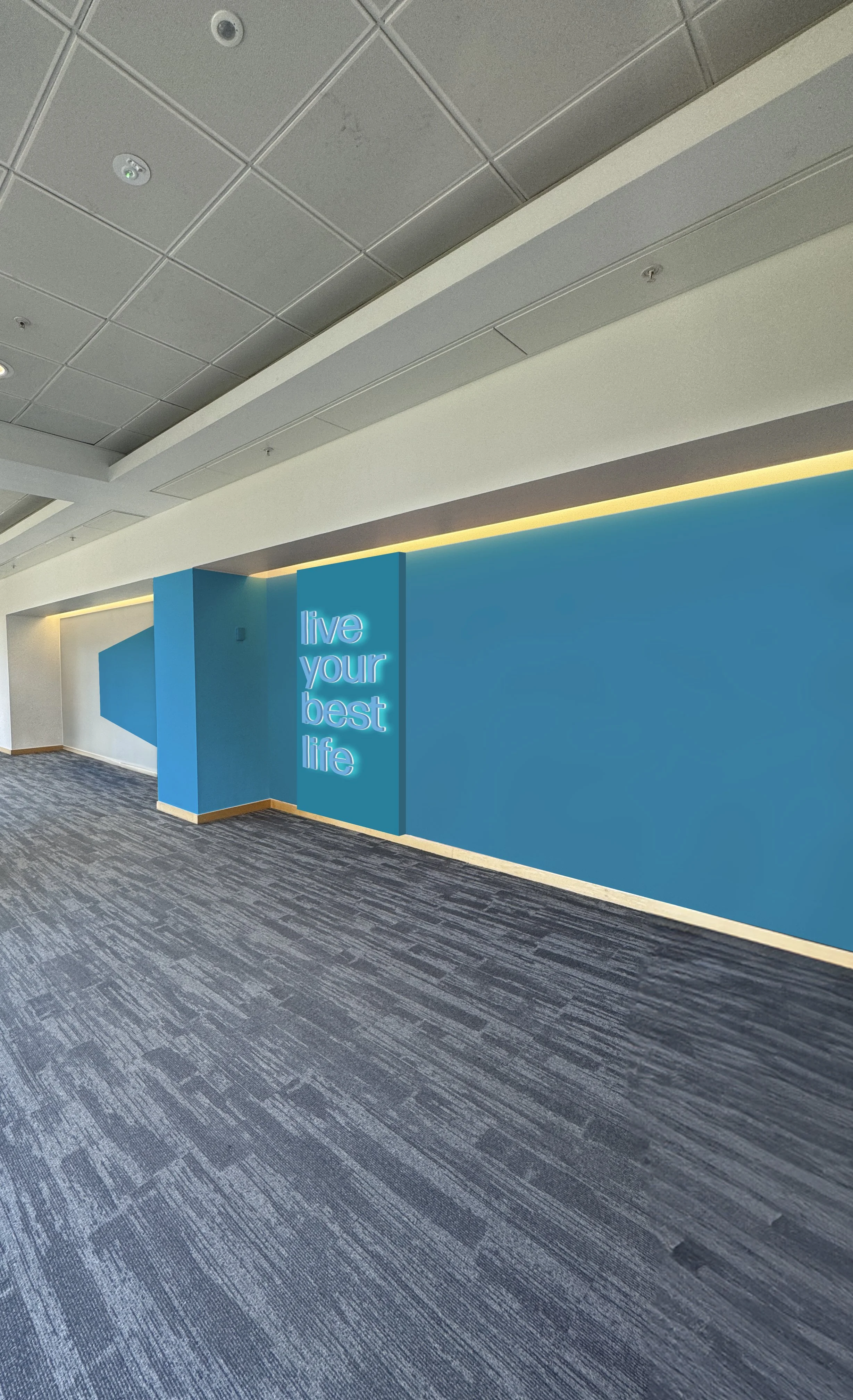 Modern indoor space with a blue accent wall, illuminated neon sign saying 'live your best life,' and gray patterned carpeting.
