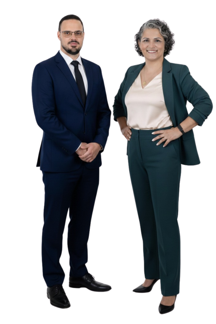 Homem e mulher empresariantes de terno sério e sorridente, posando juntos.