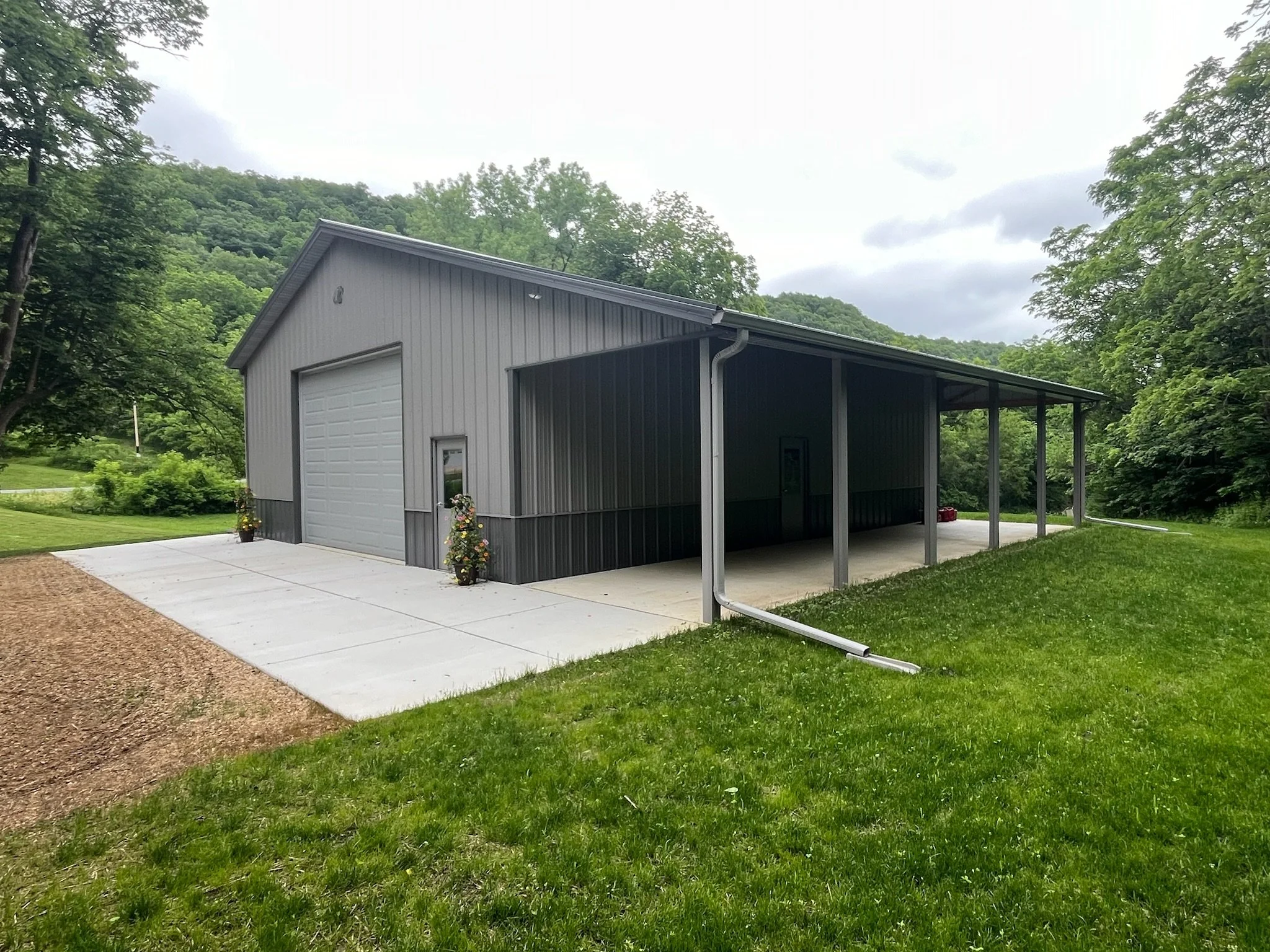 Gray pole barn with new seamless gutters