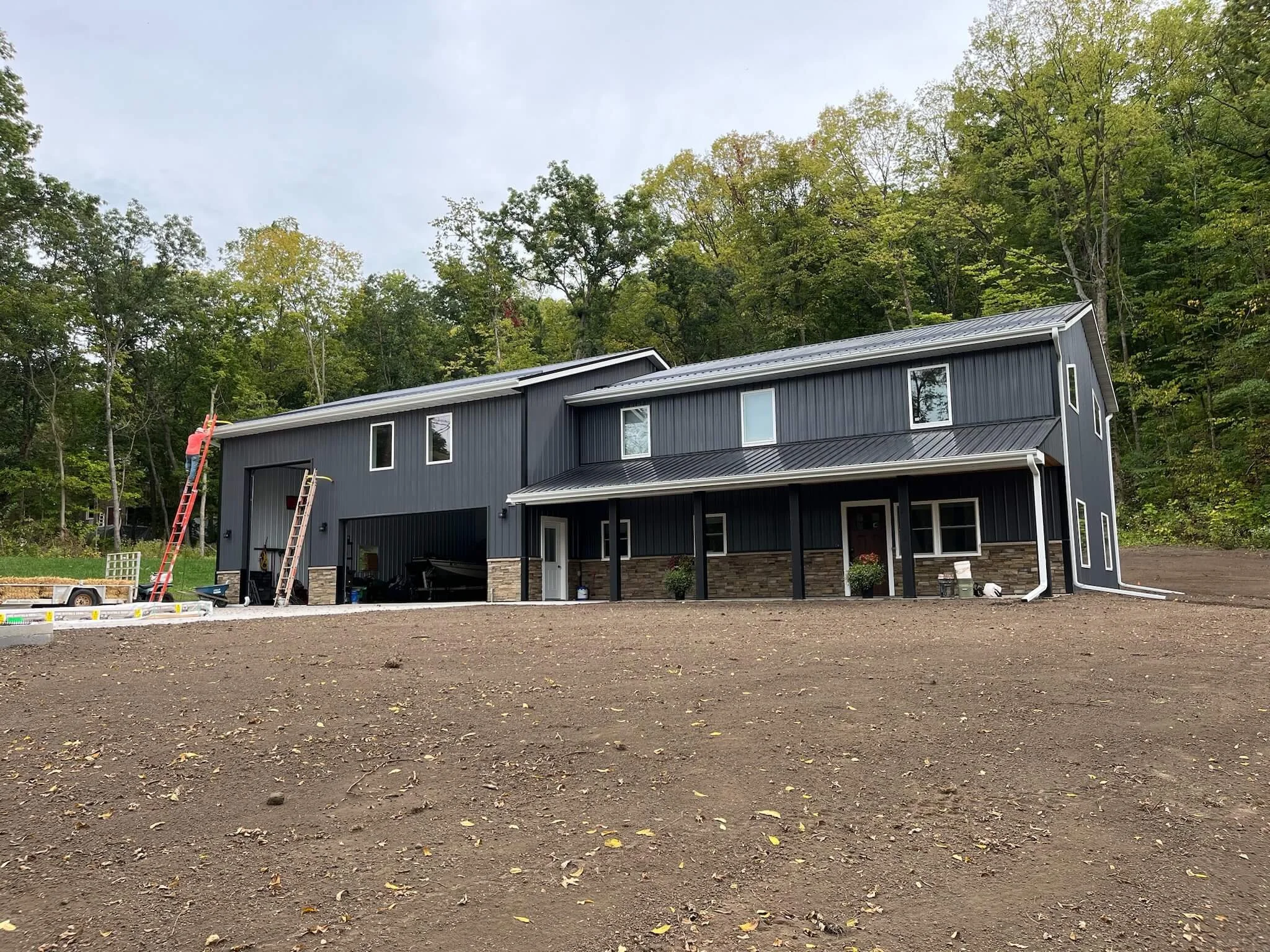 Seamless gutter installation residential project employee on ladder