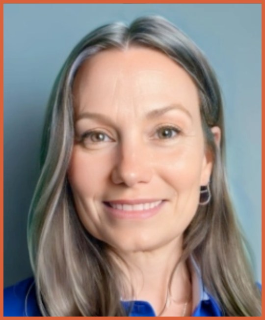 Close-up of a woman with long gray hair smiling, wearing a blue shirt, against a plain background.