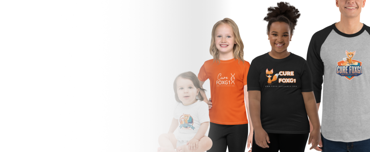 Group of four children wearing T-shirts with Cure FOXG1 logos, standing against a white background