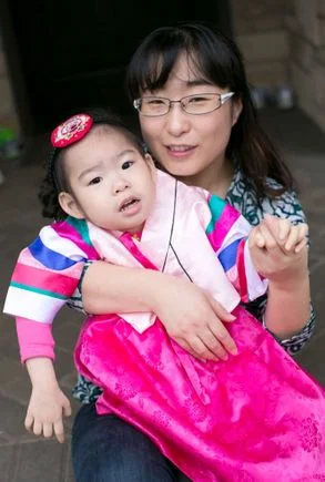 Soo-Kyung Lee, Ph.D., with her daughter Yuna. (Courtesy of the Lee family)