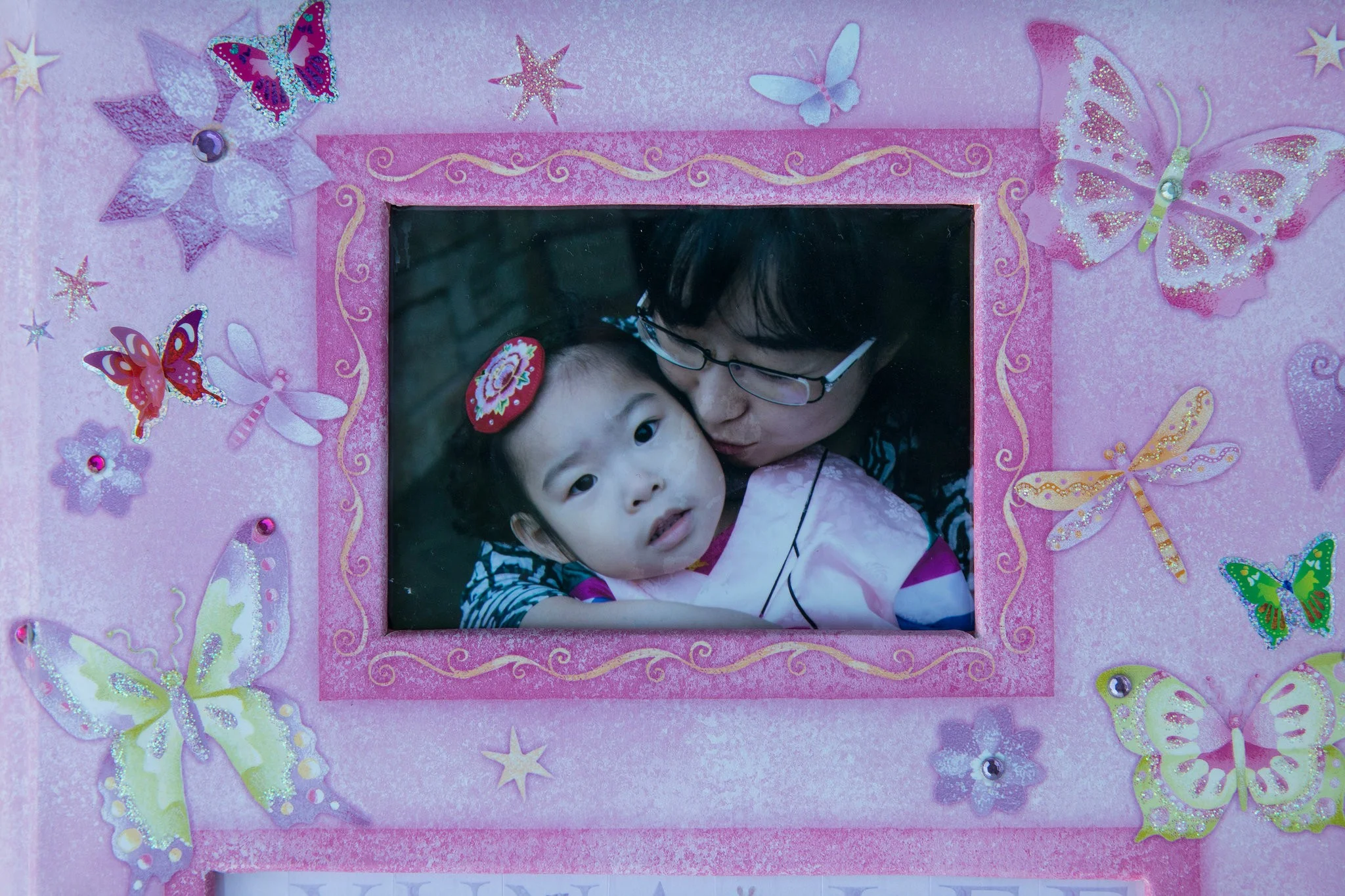 Yuna and her mother in a family photo. Born in Texas during a rare snowfall, her name, Yuna, means “snow girl” in a Korean dialect.