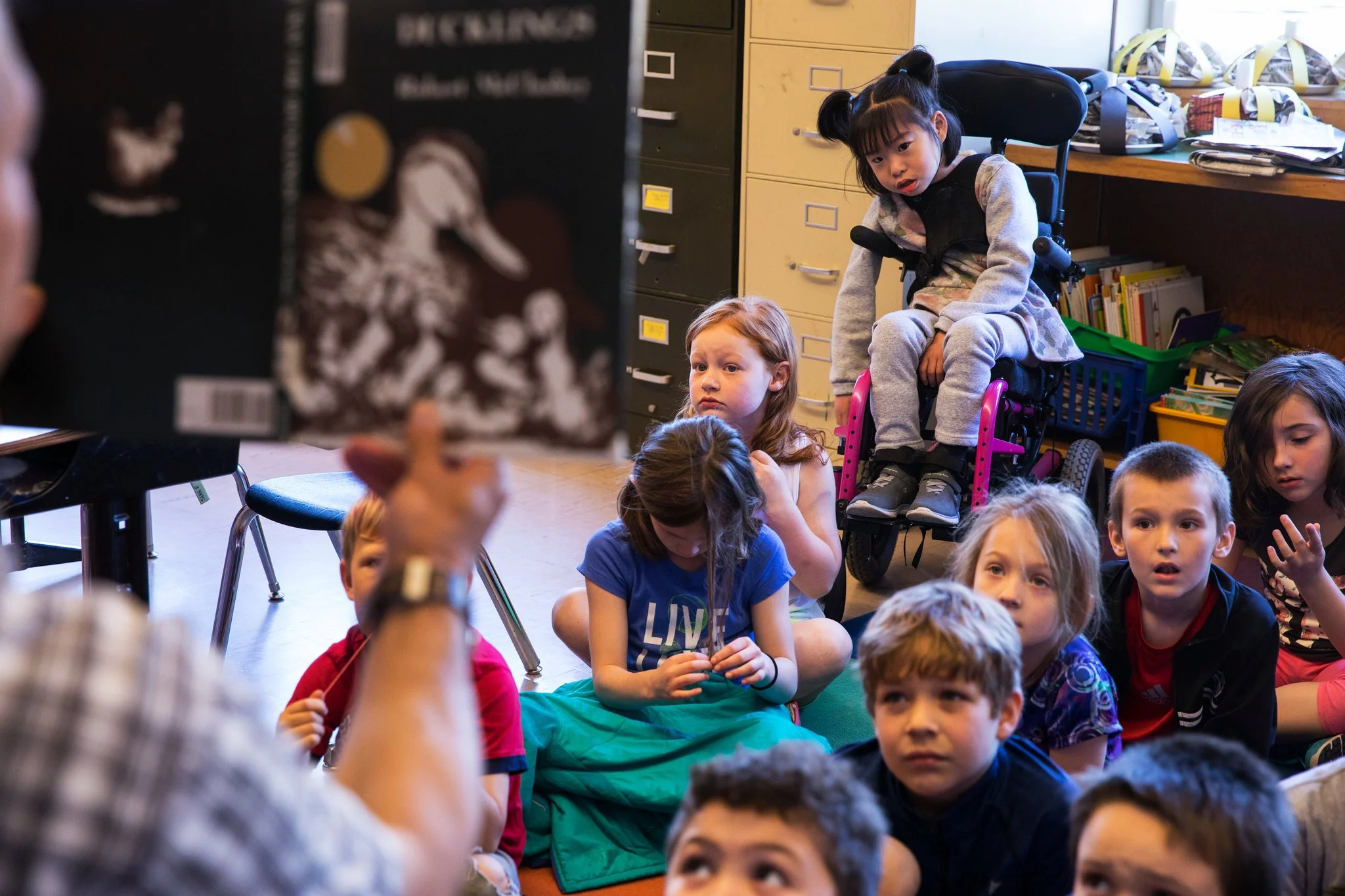 Listening to a teacher read.CreditRuth Fremson/The New York Times