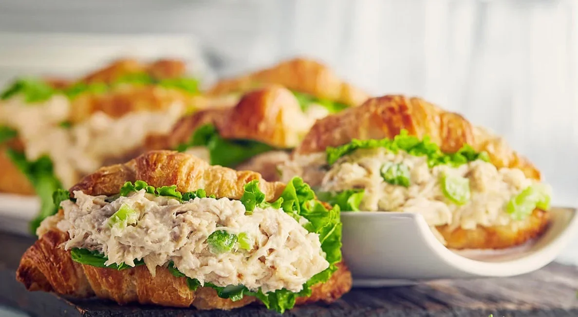 Close-up of chicken salad croissant sandwiches on a tray