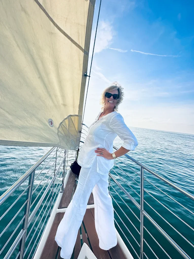 A woman smiling on the bow of Schooner Clearwater