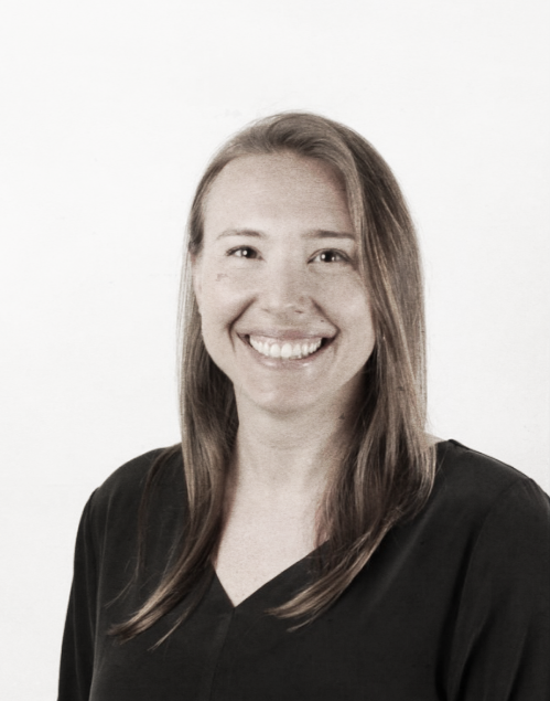 Smiling woman, Laura Chilton, with long hair wearing a black top against a plain white background.