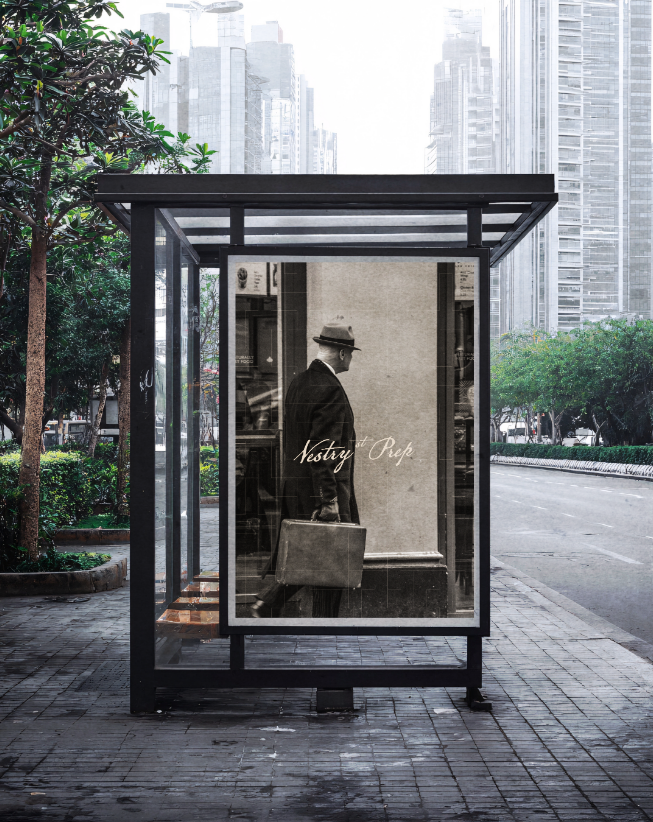 A sidewalk shelter with a black frame displaying a vintage black-and-white photo of a man in a suit and hat carrying a briefcase, with the words 'Nostry Ope' written on the photo, in an urban setting with tall buildings and trees.